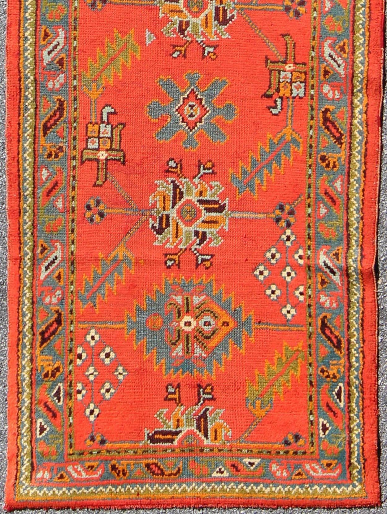 Bright red antique Turkish Oushak runner with Sub-geometric tribal motifs, rug l11-0304, country of origin / type: Turkey / Oushak, circa 1920

This antique Oushak runner features a unique blend of cheerful colors and an intricately beautiful