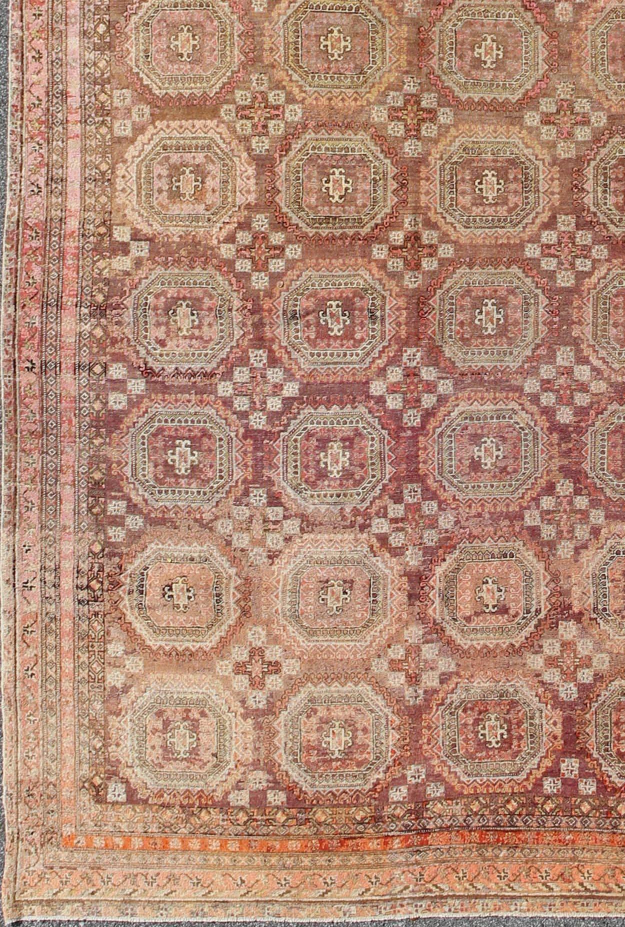 Antique Khotan rug with repeating medallion design in maroon / red, mpc-538, country of origin / type: Russia / tribal, circa 1900/early 20th century

This piece is a rare antique carpet from Turkestan with delightful colors and all-over repeating