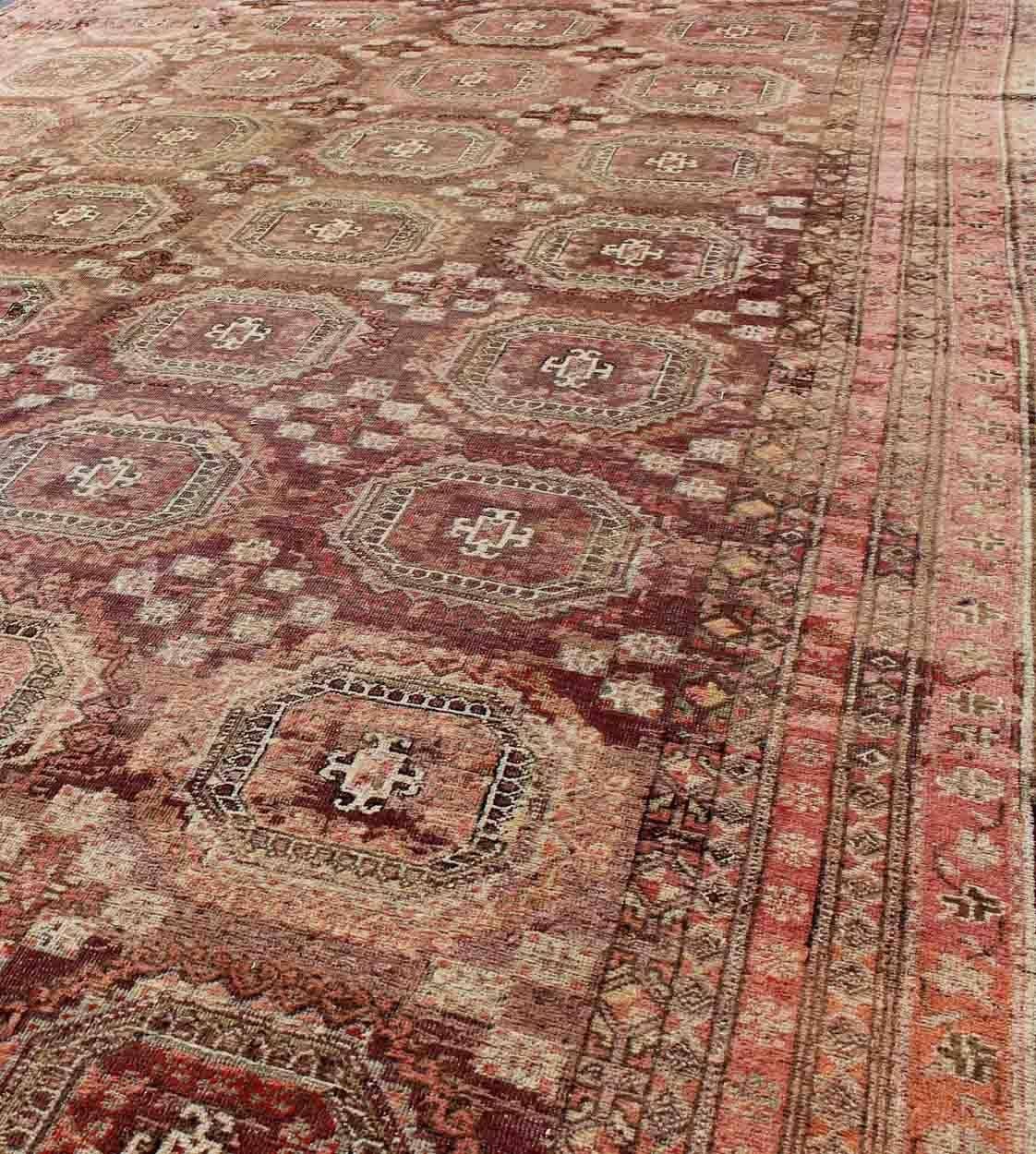 Hand-Knotted Antique Large Khotan Rug with Repeating Medallion Design in Maroon / Red For Sale