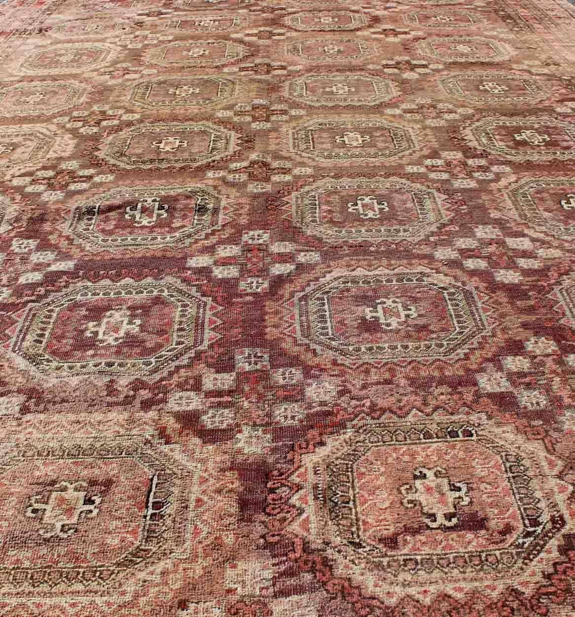 Antique Large Khotan Rug with Repeating Medallion Design in Maroon / Red In Good Condition For Sale In Atlanta, GA
