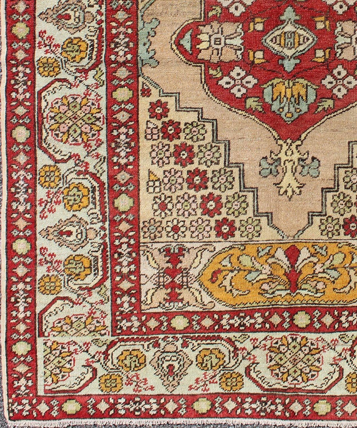 Sub-geometric floral medallion antique Turkish Oushak rug in red, gold, cream, rug osm-04, country of origin / type: Turkey / Oushak, circa 1930

This Turkish Oushak rug features a medallion design as well as patterns of smaller sub-geometric floral