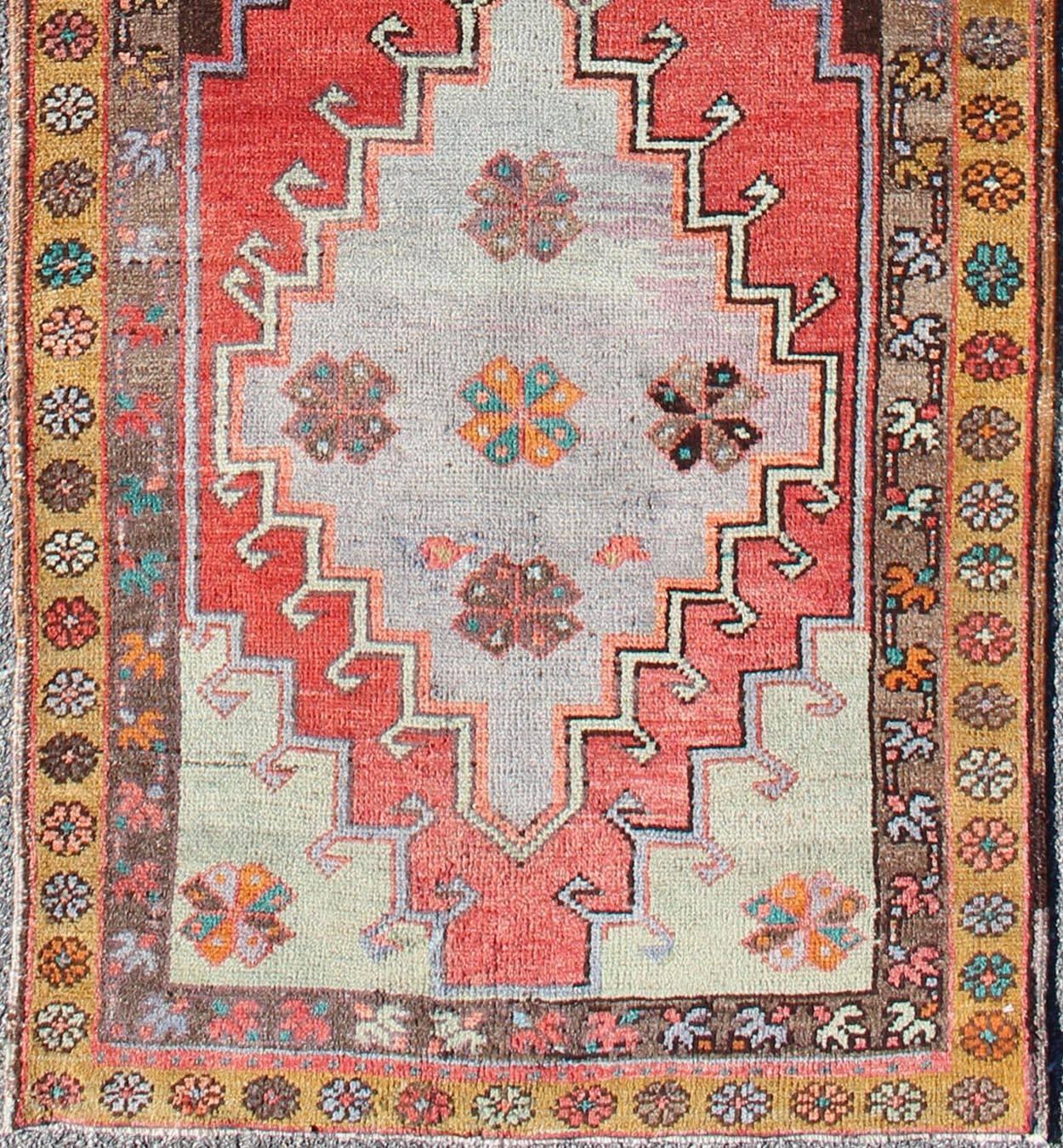 This vintage Oushak runner features a unique blend of cheerful colors and an intricately beautiful design. The Sub-geometric tribal medallions are complemented by other Sub-geometric elements in the surrounding cornices and border. The various