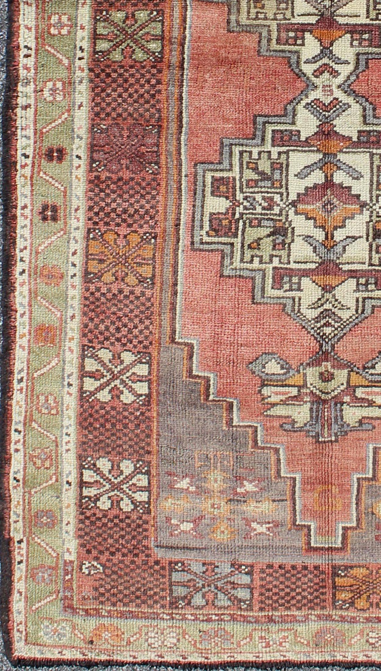 Soft red and green vintage Turkish Oushak rug with sub-geometric dual medallions, rug tu-trs-3435, country of origin / type: Turkey / Oushak, circa 1940

This Turkish runner features a dual central medallion design as well as patterns of smaller