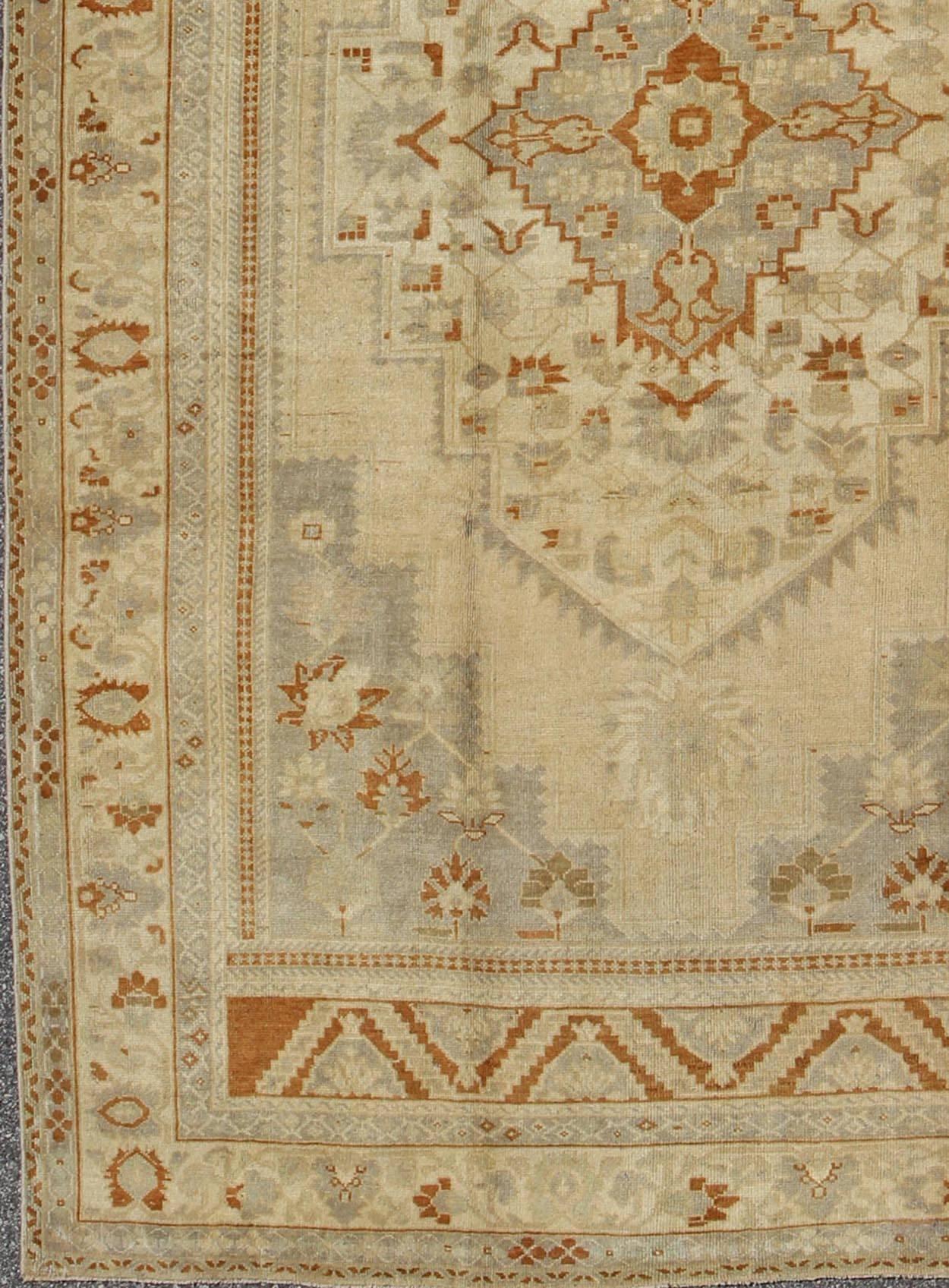 Measures: 6'10'' x 11'3''.
This Oushak carpet (circa mid-20th century) features a multi-layered medallion framed in the central field. Complementary floral designs adorn the surrounding field, cornices and borders. Colors include ivory, light gray,