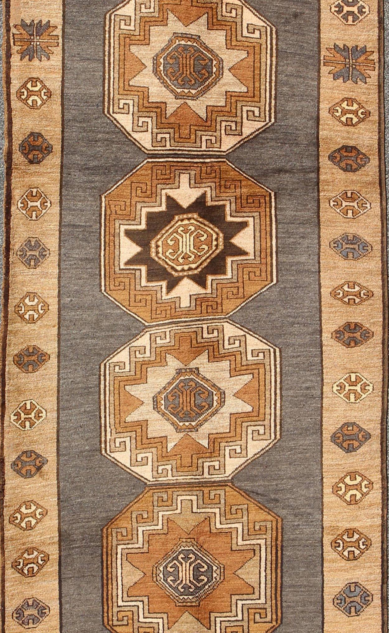 Hand-Knotted Shades of Brown Vintage Turkish Oushak Runner with Vertical Medallion Design For Sale