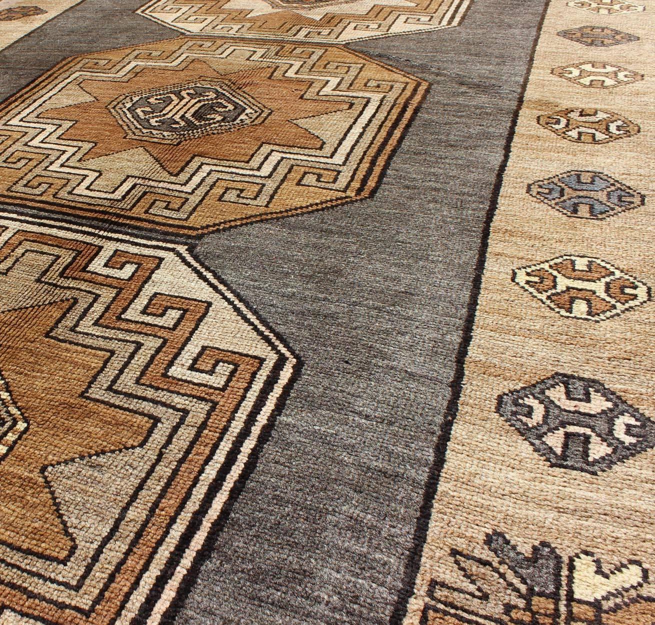 Mid-20th Century Shades of Brown Vintage Turkish Oushak Runner with Vertical Medallion Design For Sale