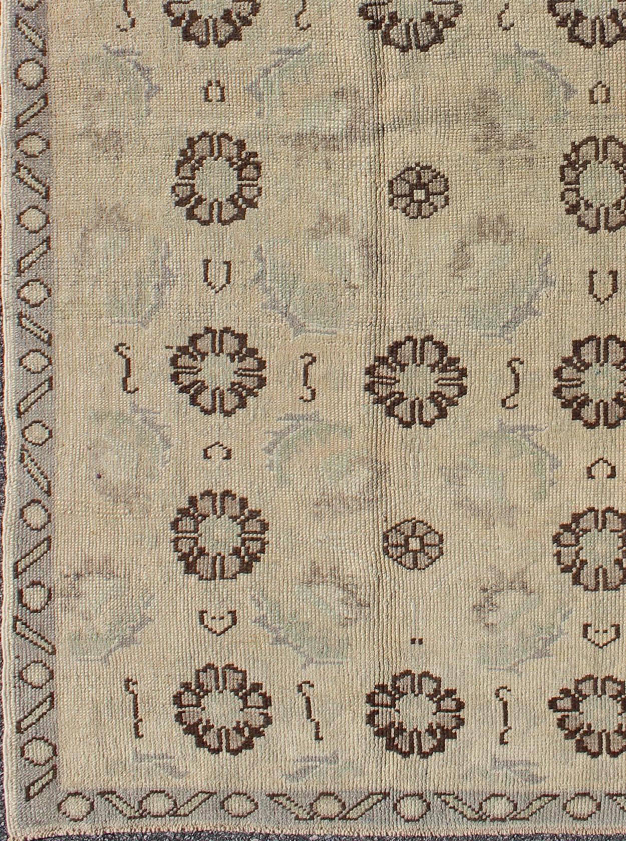 Blossom and tribal design vintage Turkish Oushak rug in nude, taupe, gray, brown, rug tu-TRS-136520, country of origin type: Turkey Oushak, circa 1930.

This Oushak carpet (circa 1930) features an all-over pattern of floating vertically-arranged