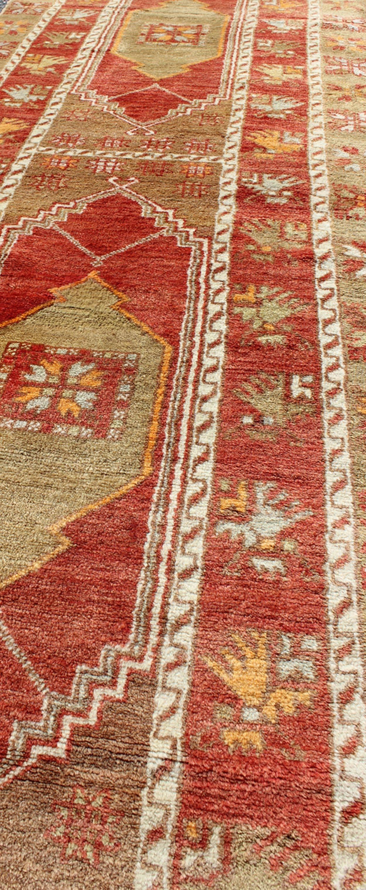 Mid-20th Century Red and Green Vintage Turkish Oushak Runner with Tribal Dual Medallions For Sale