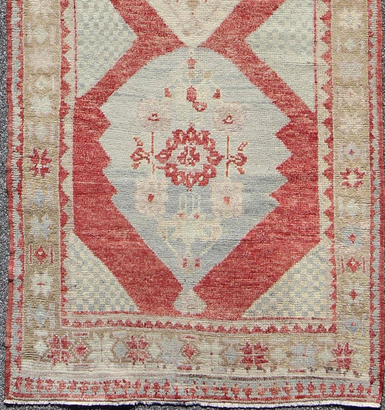 1930's Layered Medallion Vintage Turkish Oushak Runner in soft Red, Lt. Blue, Cream, rug TU-UGU-3601, country of origin / type: Turkey / Oushak, circa mid-20th Century.  

Measures: 3'8'' x 9'7''

This beautiful vintage Oushak runner from 1930s