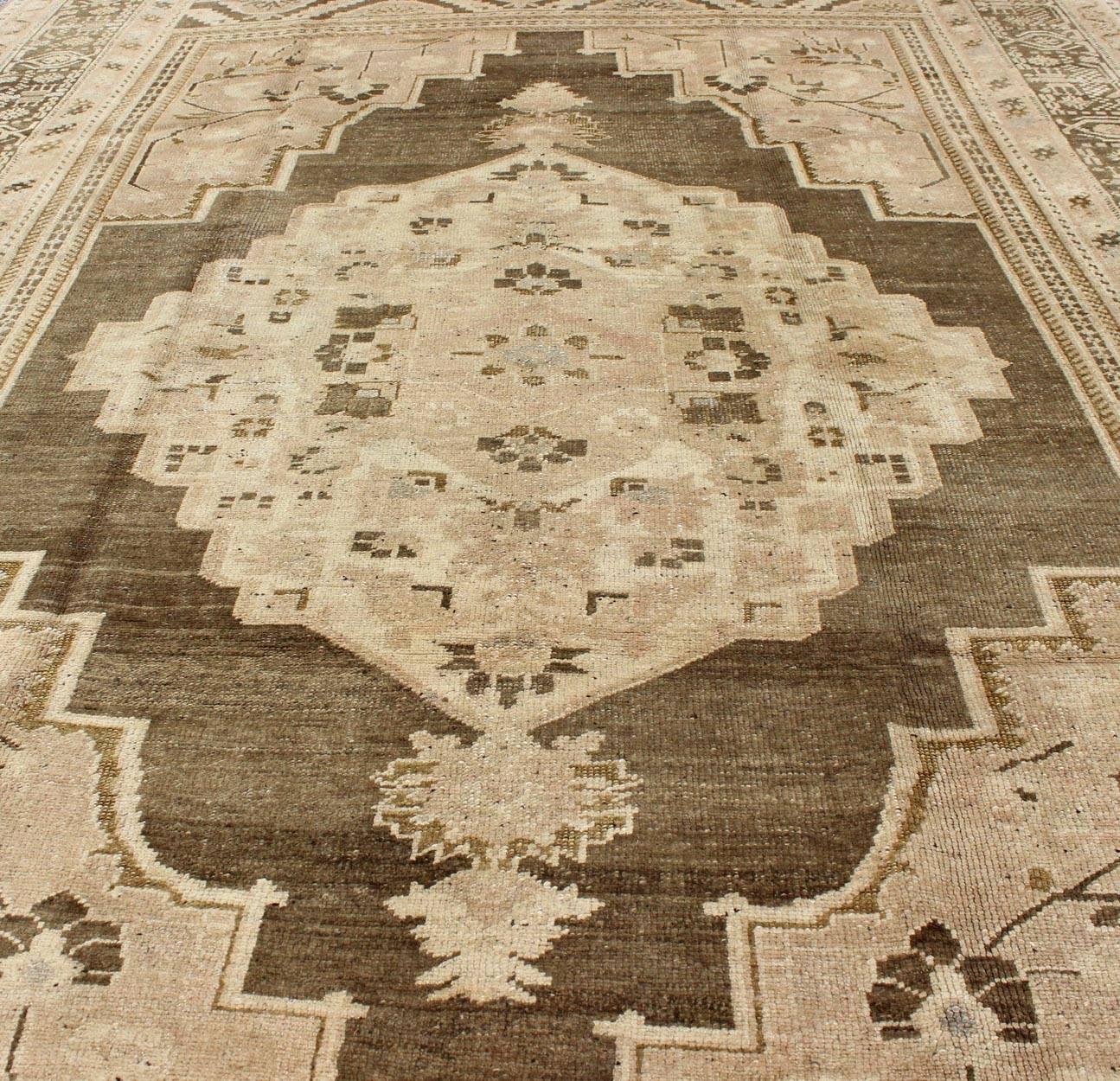 Mid-20th Century Earth Tone Vintage Turkish Oushak Rug with Tribal Geometric Designs For Sale