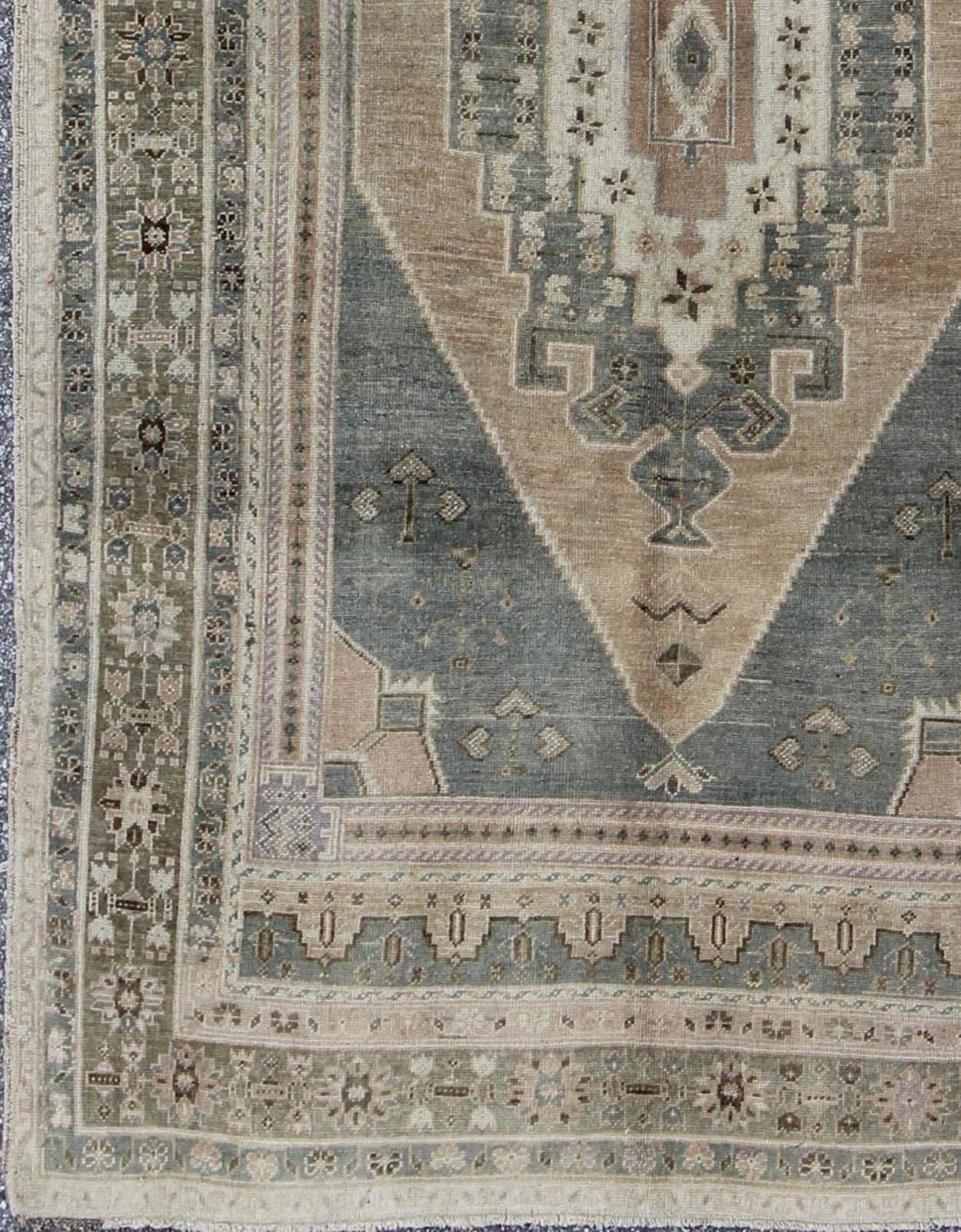 Vintage Oushak in Gray Green, Beige, Camel Background and Light Green Border. 
Rug / TU-UGU-136007
This unique Turkish Oushak has a Gray green background along with warm Camel, taupe and a light green border. The geometric design is softened by the
