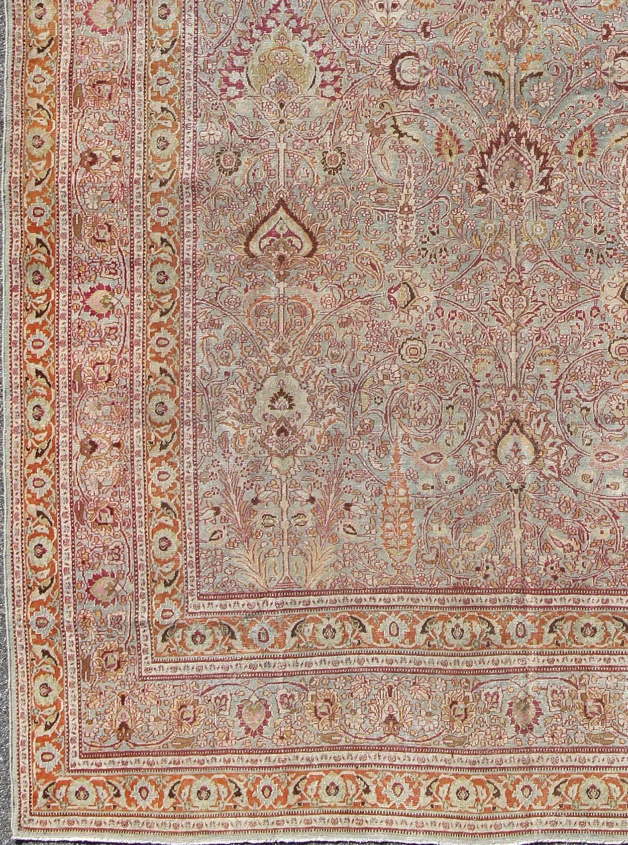 Antique Persian Khorassan rug with floral design in Gray-Blue background, orange, red pink, rug 16-0916, country of origin / type: Iran / Khorassan, circa 1900

This spectacular antique Persian Khorasan carpet from early 20th century Iran bears a
