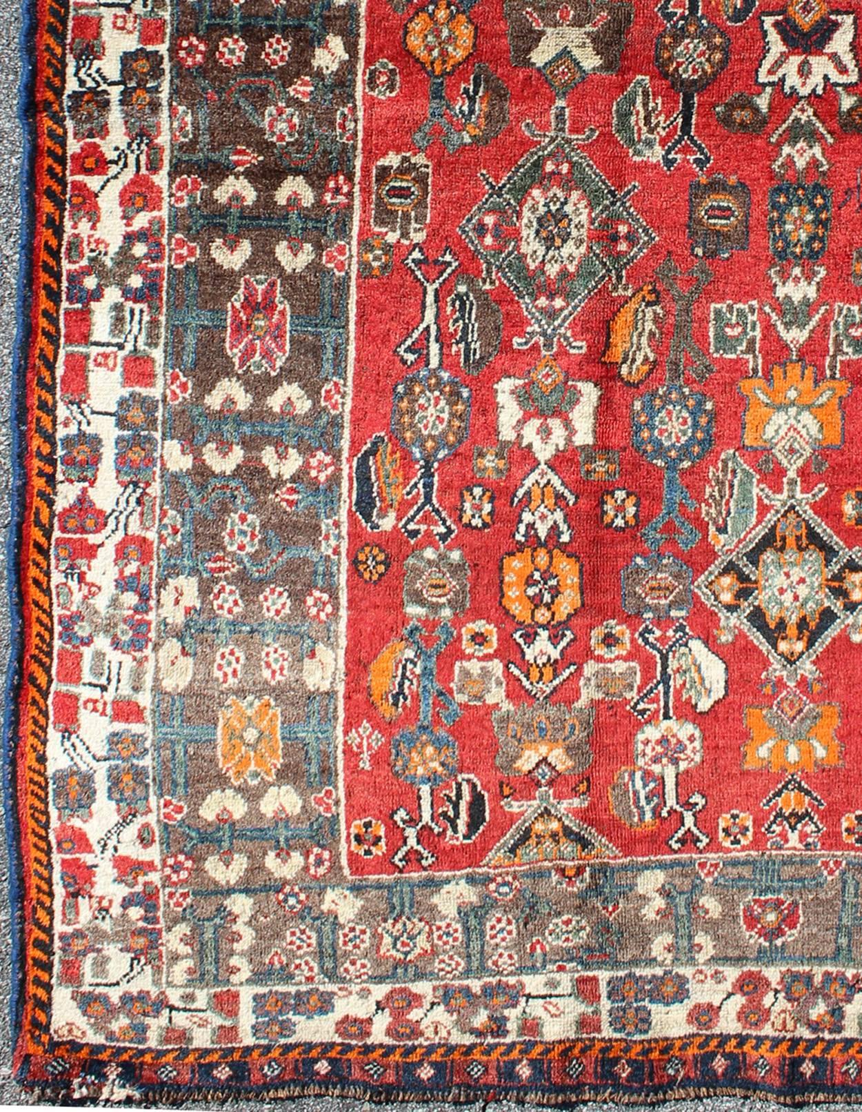 Red background Shiraz Persian Vintage rug with Sub-Geometric Motifs Throughout, rug h-1211-52, country of origin / type: Iran / Shiraz, circa 1950

This vintage Persian Shiraz rug (circa mid-20th century) features a unique blend of colors and an