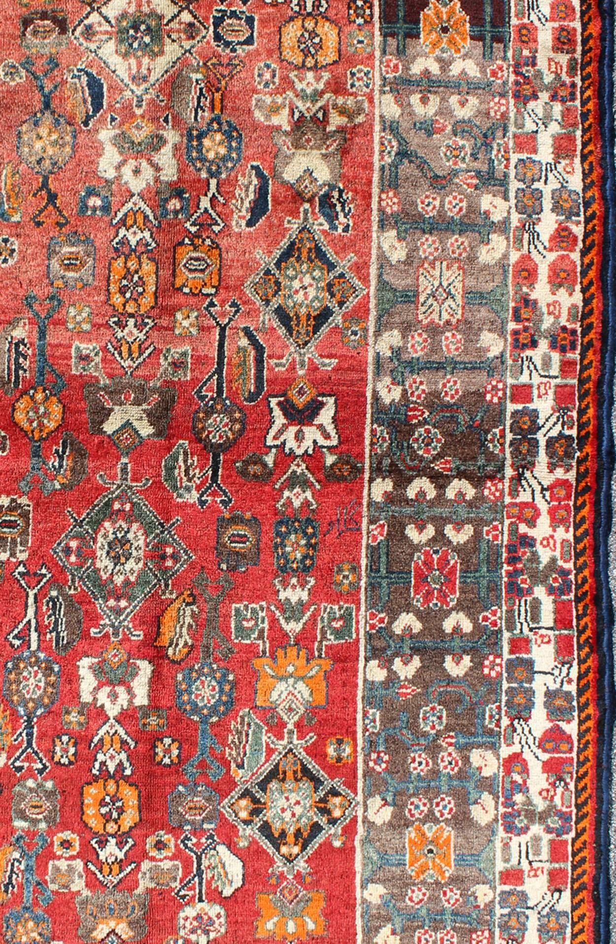 Hand-Knotted Red Background Shiraz Persian Rug with Sub-Geometric Motifs Throughout