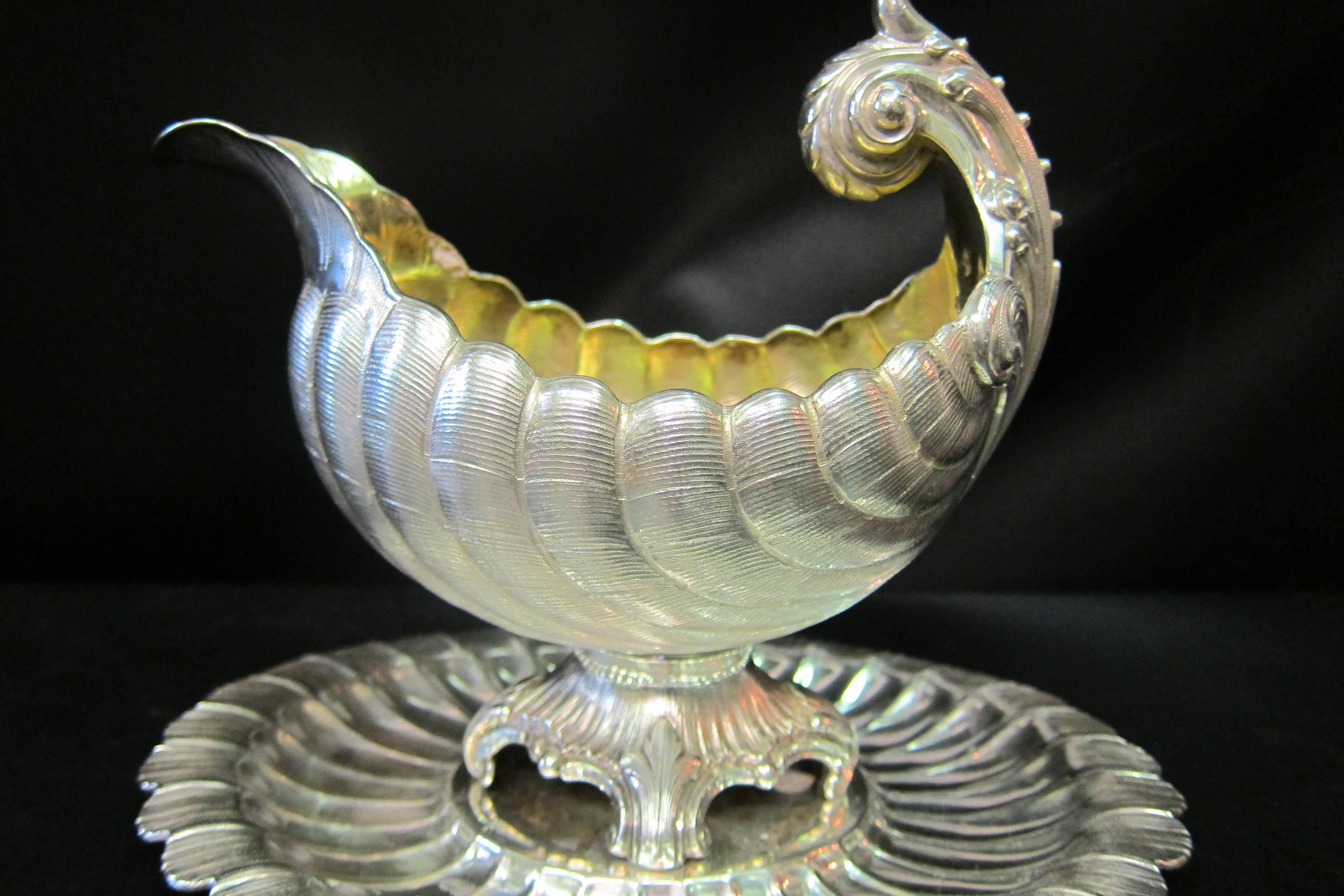Circa late 19th century, German silversmith, Lazarus Posen, designed this stunning stylized shell sauce boat featuring a hand rendered textured scallop pattern. Posen created this 800 silver piece commissioned by the Wilkens & Sohne company. The