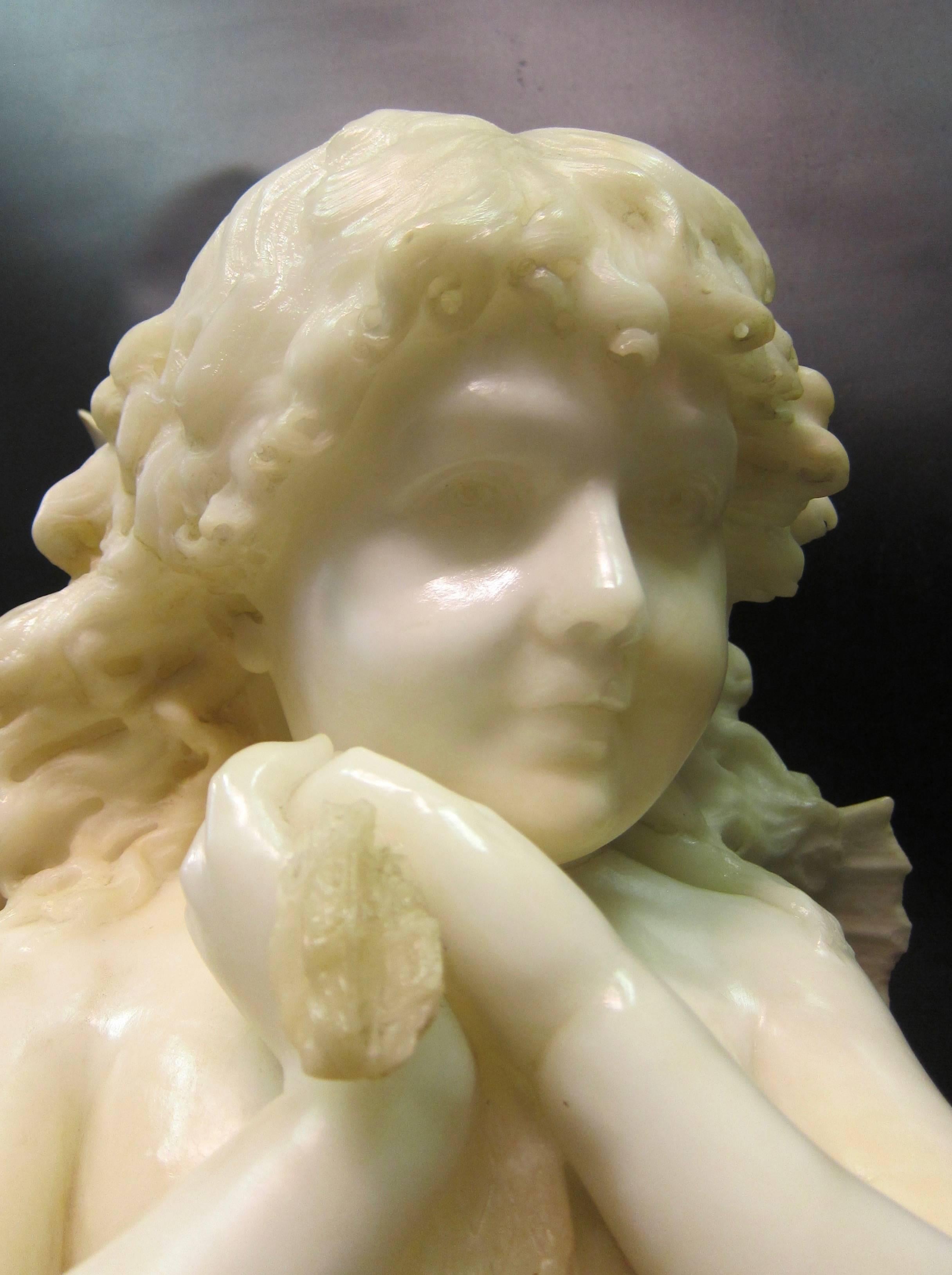 This vintage late 19th century hand carved marble bust is of a charming child like fairy. The sculpture is signed by the artist, Enrico Lapini, 1891. This beautiful white marble is masterfully carved & mounted upon a rouge colored platform base.