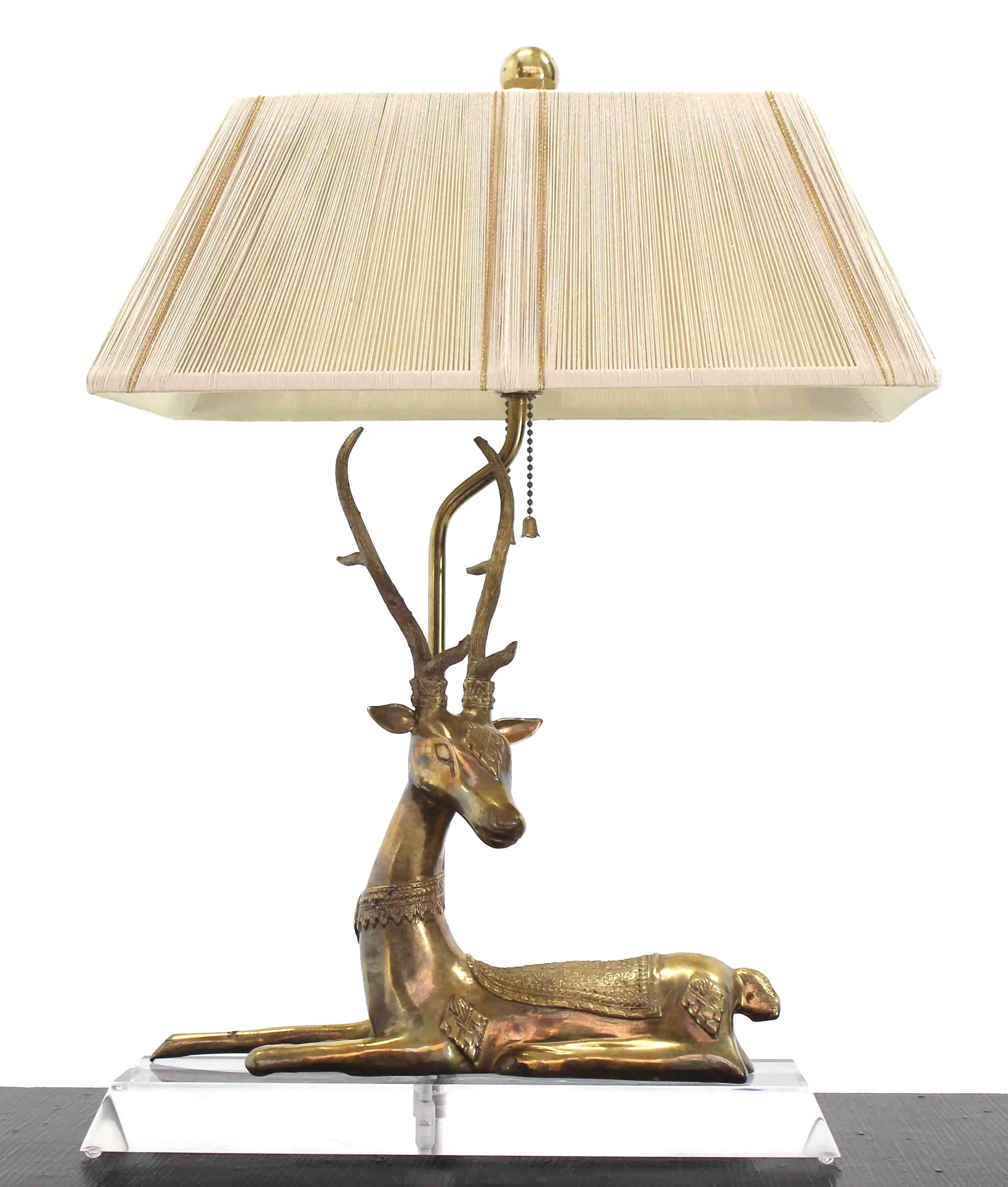 Decorative deer sculpture table lamp on Lucite base.