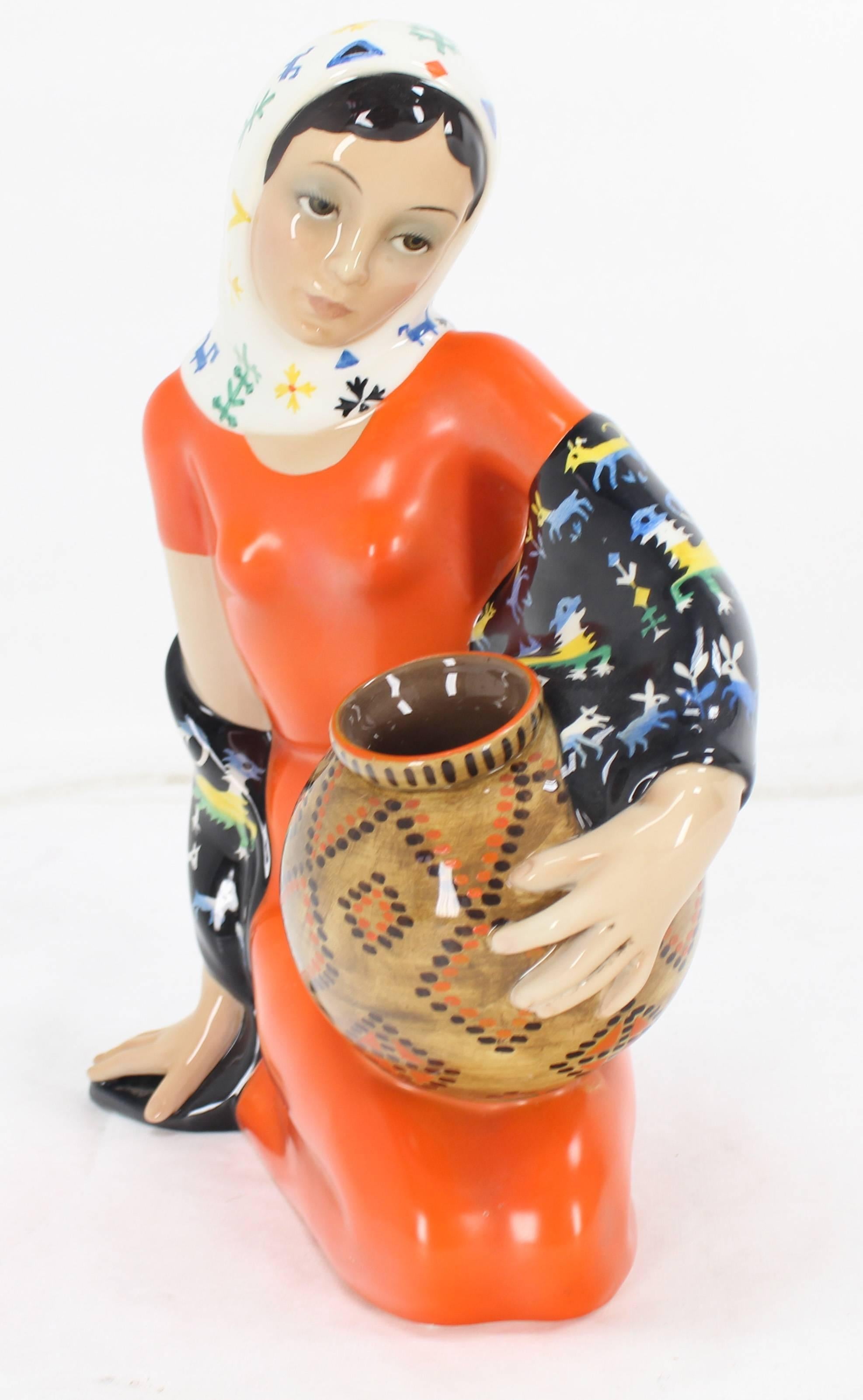 Italian porcelain figurine of a young girl in red dress holding a basket or vase from Lenci Torino, Italy.