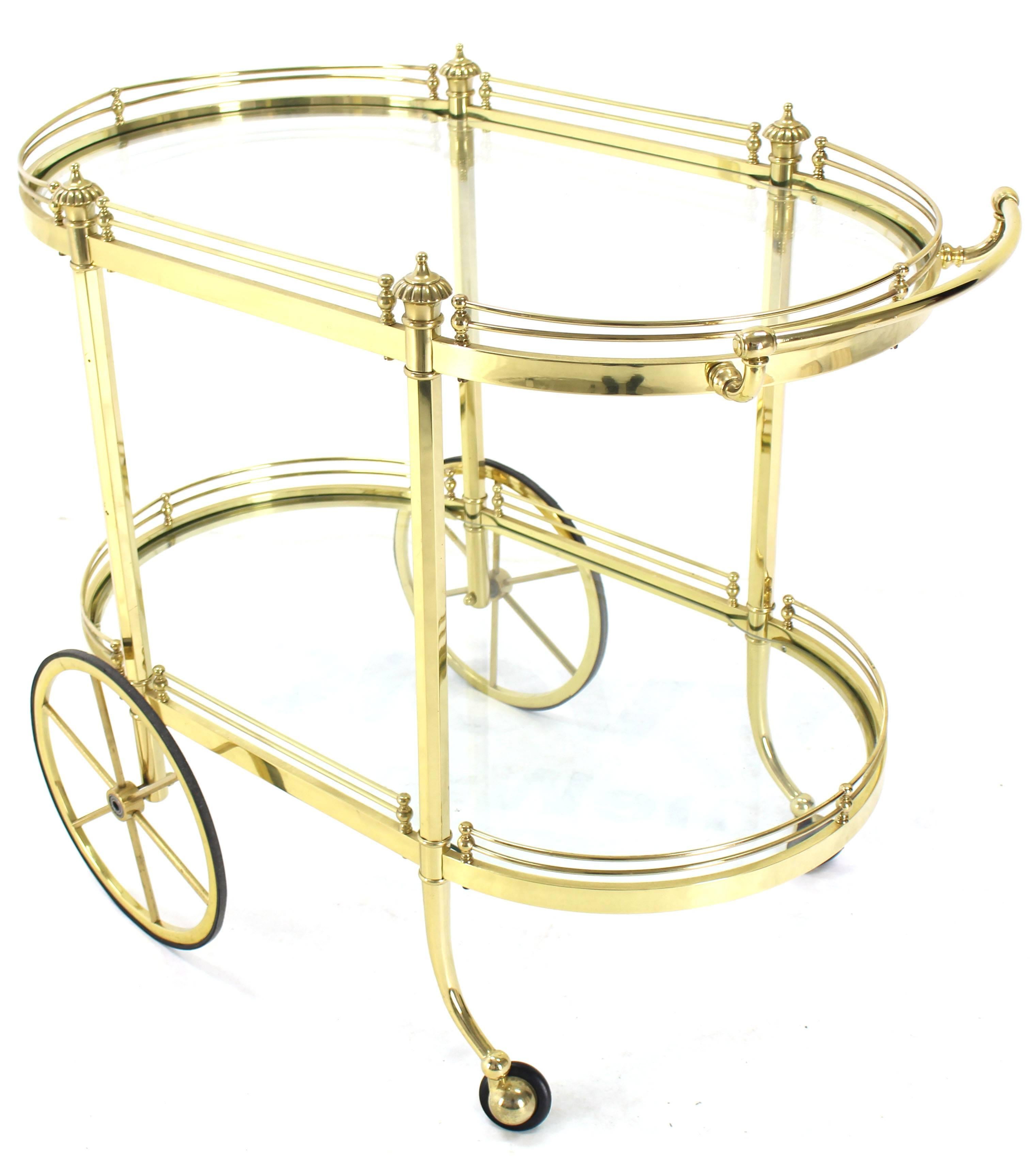 Decorative polished brass serving tea bar cart. Larger carriage style wheels.