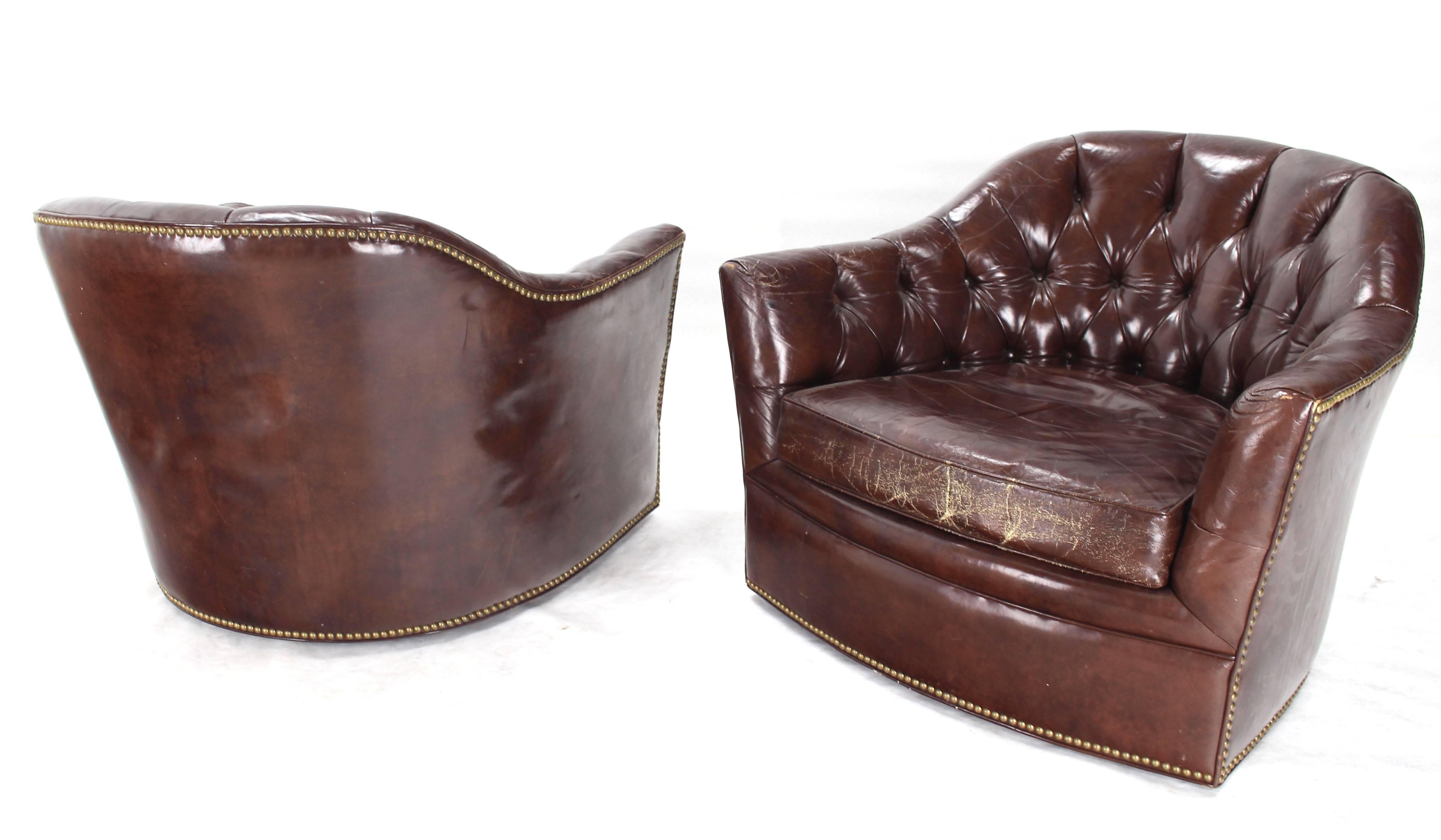 Very nice pair of leather swivel lounge barrel back chairs. Tufted Chesterfield style leather back. Nice wear/patina.