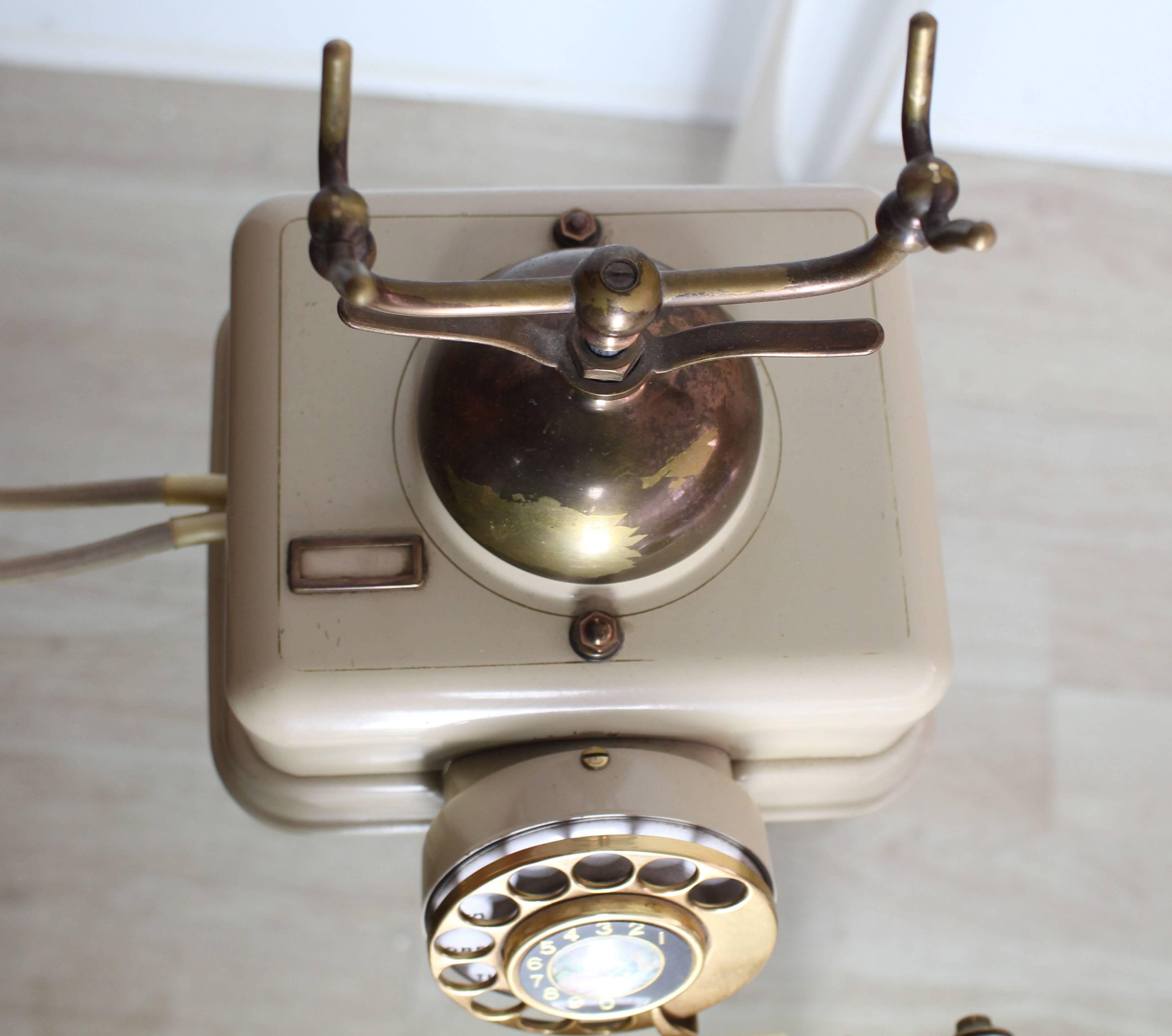 Excellent original condition antique vintage rotary telephone. Creme color plastic and brass materials combination.