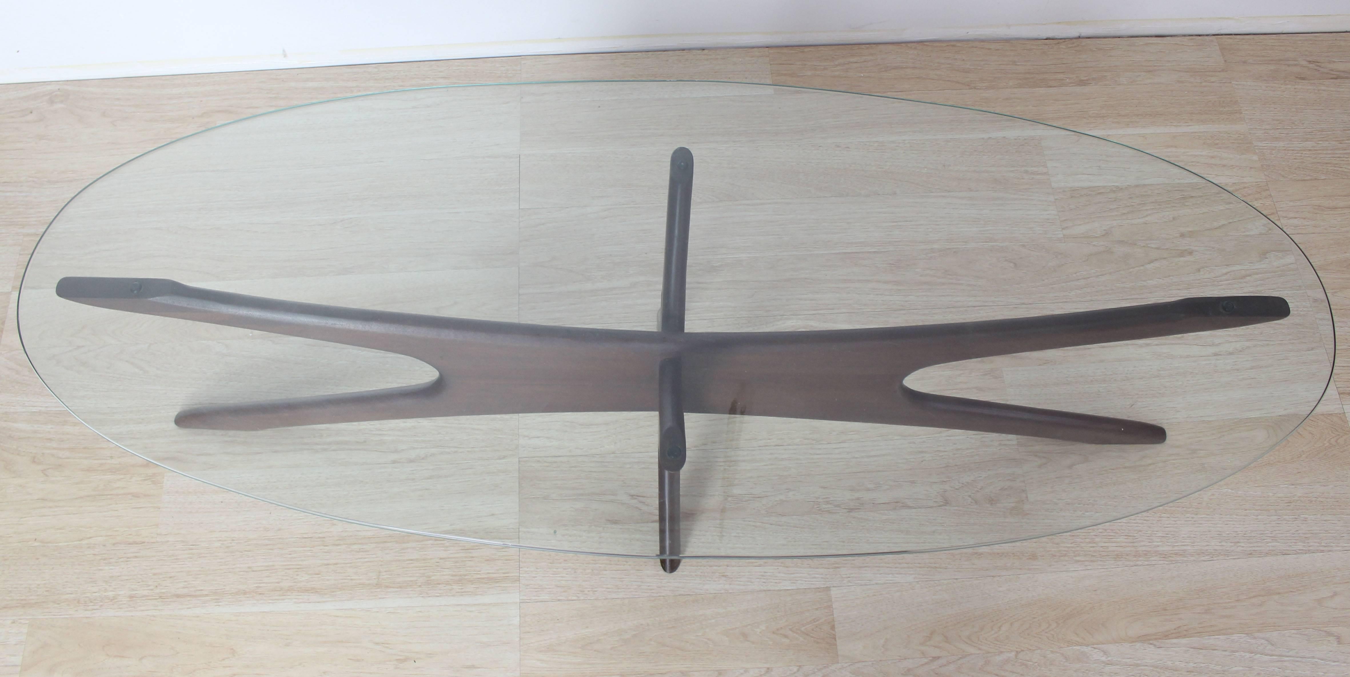 Mid-Century Modern walnut star shape base oval glass top coffee table by Adrian Pearsall.