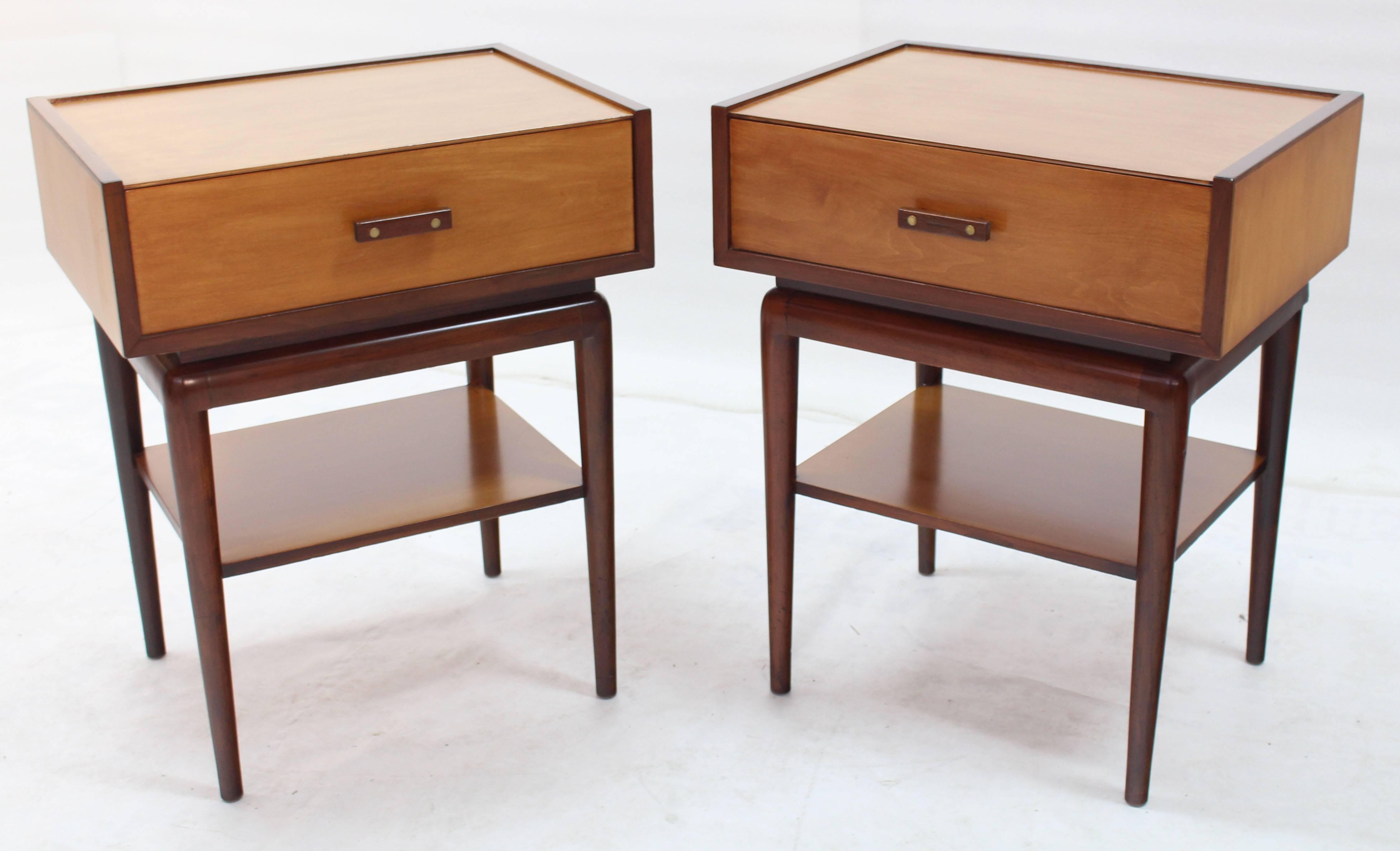 Mid-Century Modern nightstands on tall tapered legs with one shelf.