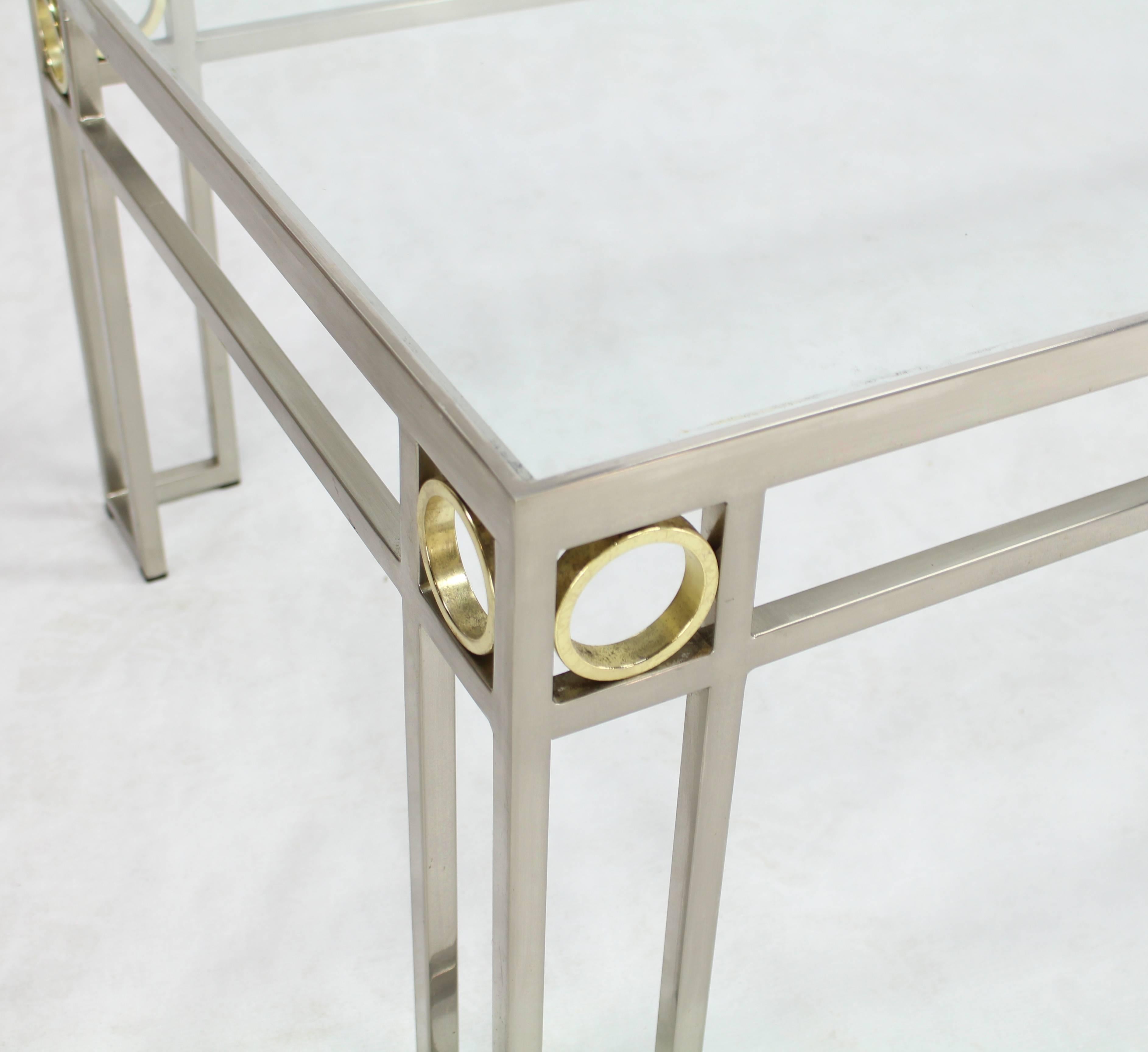 Mid-Century Modern rectangular glass top coffee table. Chrome frame shape base with brass accent rings. glass top.