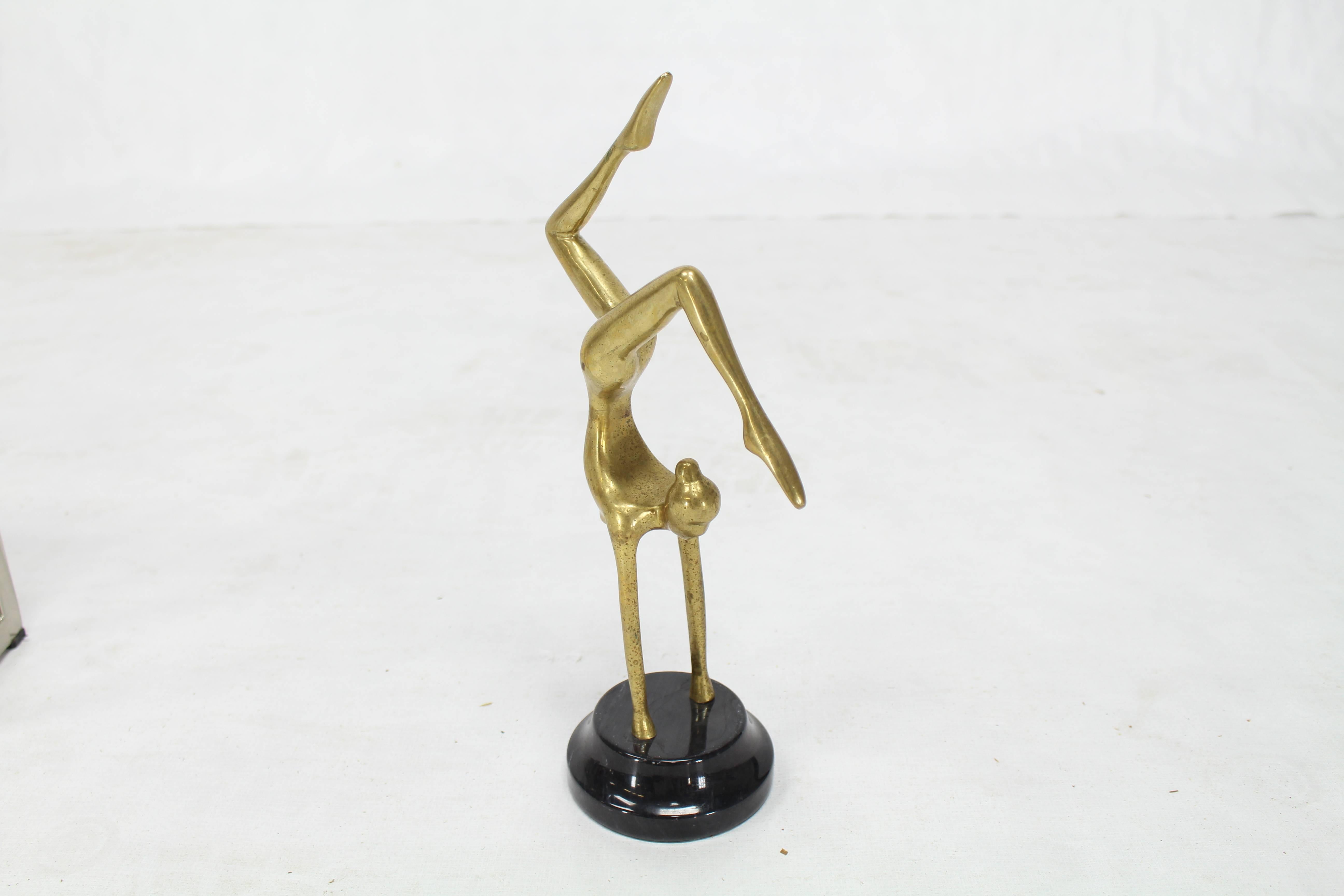 Modern abstract sculpture of gymnast on marble base. Measures: 12 inches.