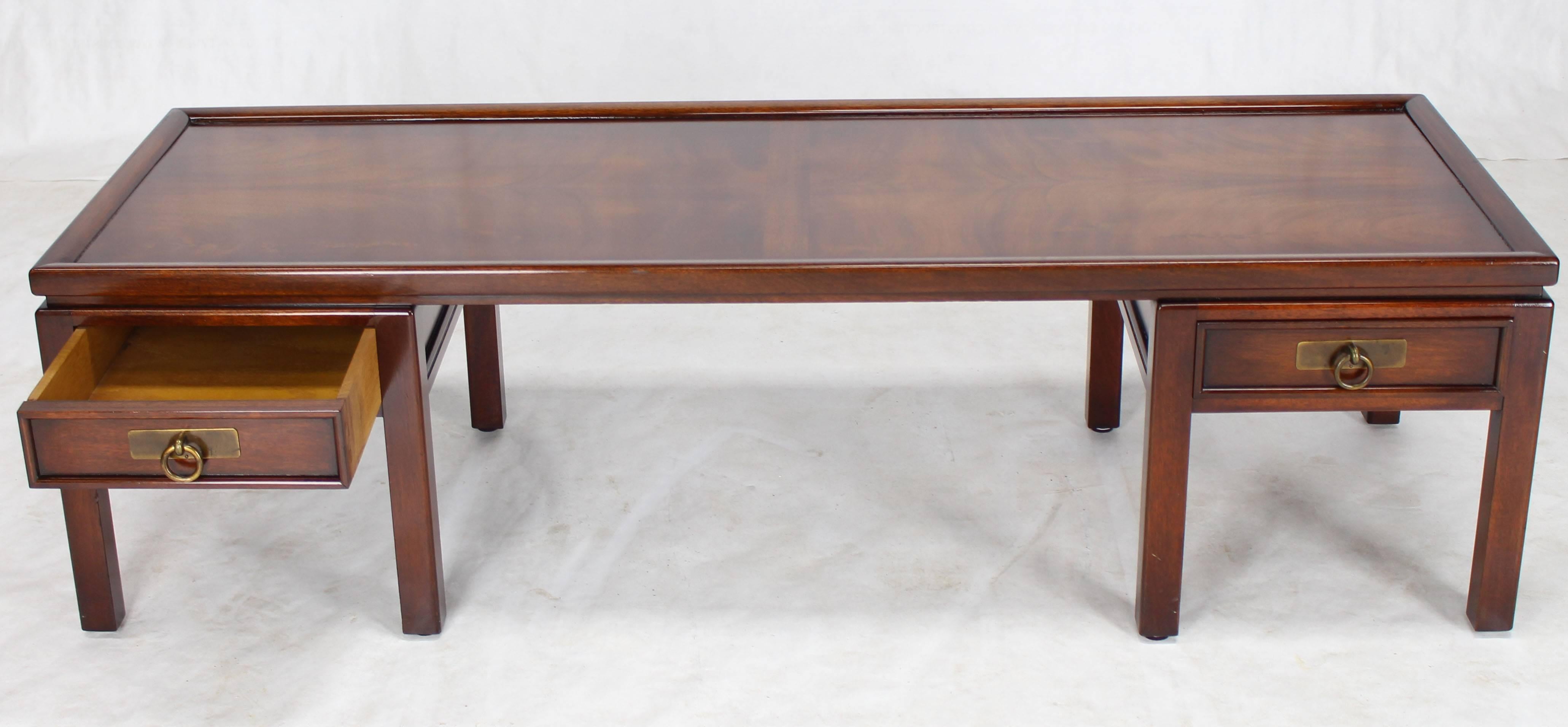 Mid-Century Modern double pedestal flame mahogany coffee table with two drawers.
