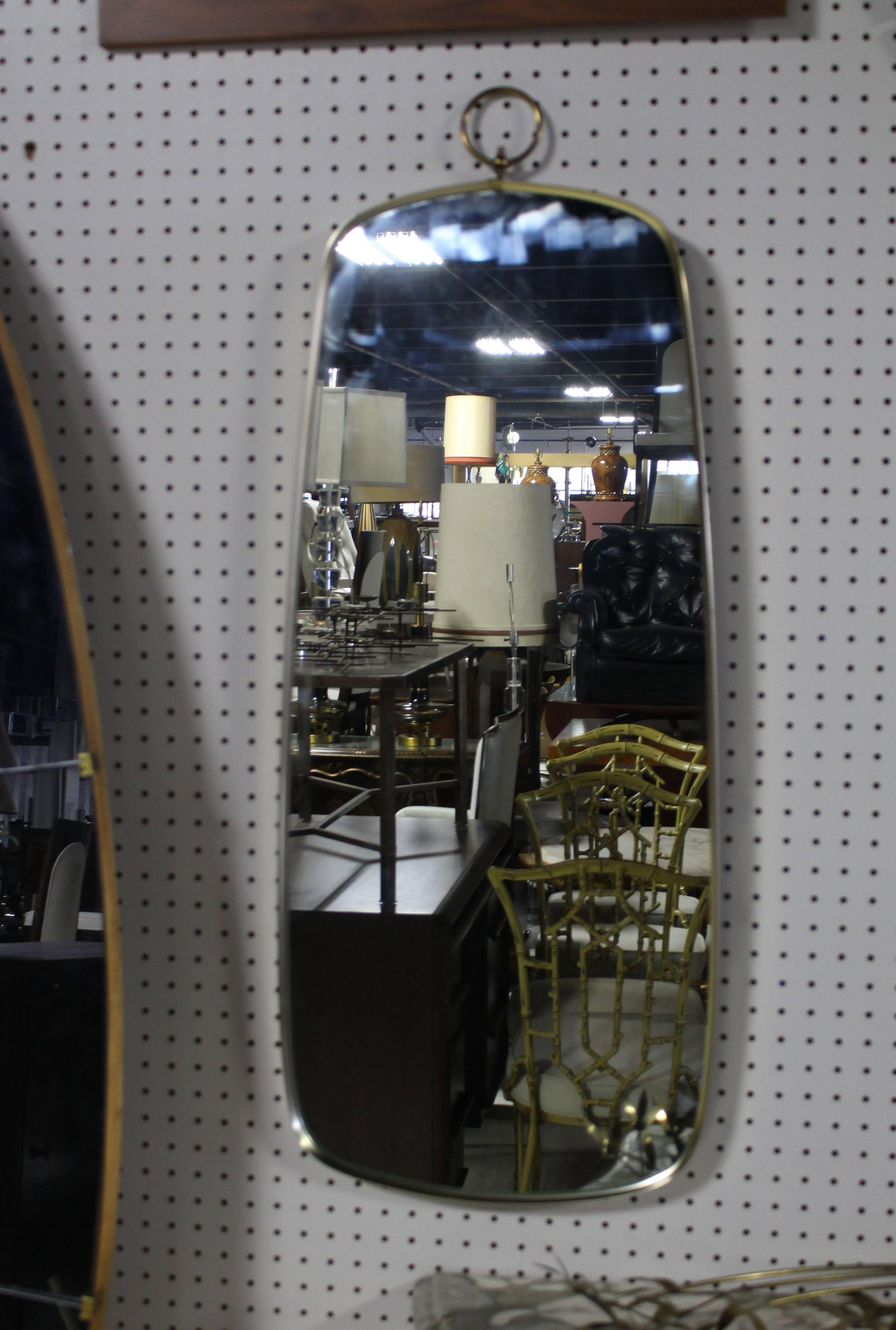Mid-Century Modern American medium size hall mirror. Famed in metal nice ring fenial.