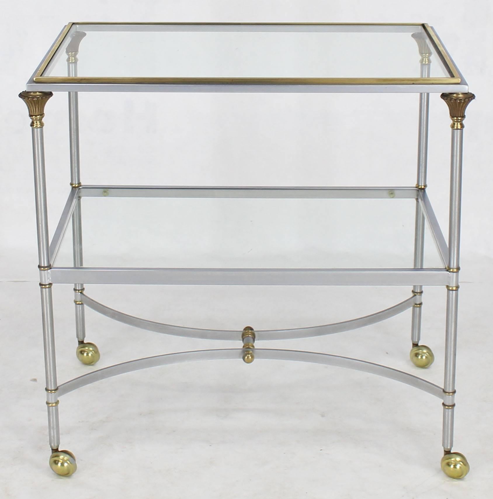 Brushed chrome brass finials glass shelves serving cart side table on wheels.