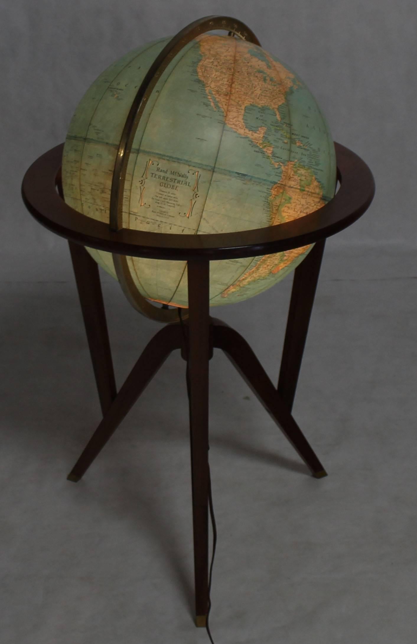 Walnut and brass tripod or tri-leg base stand Mid-Century Modern illuminated globe by Ed Wormley.