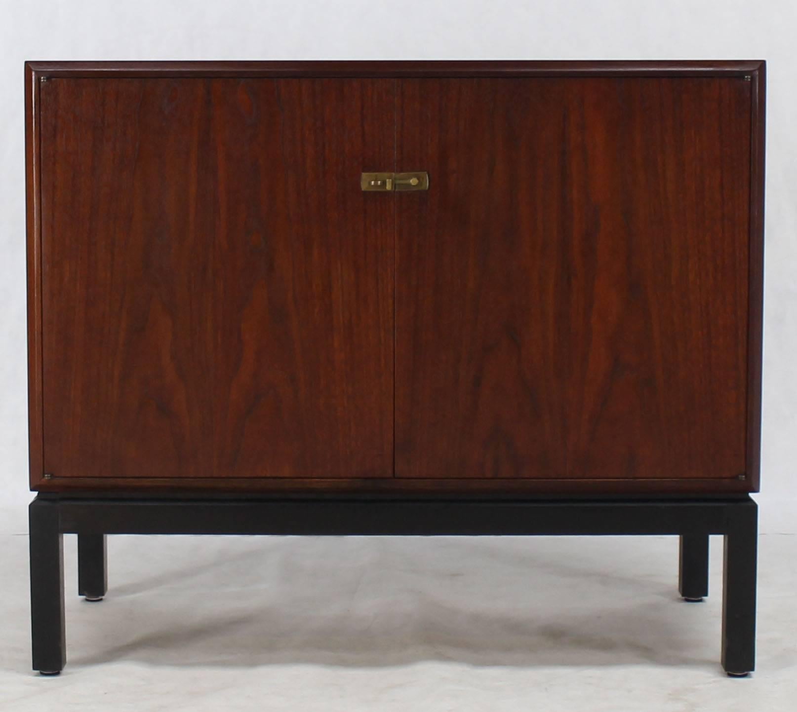 Mid-Century Modern two doors oiled walnut credenza with brass latches.