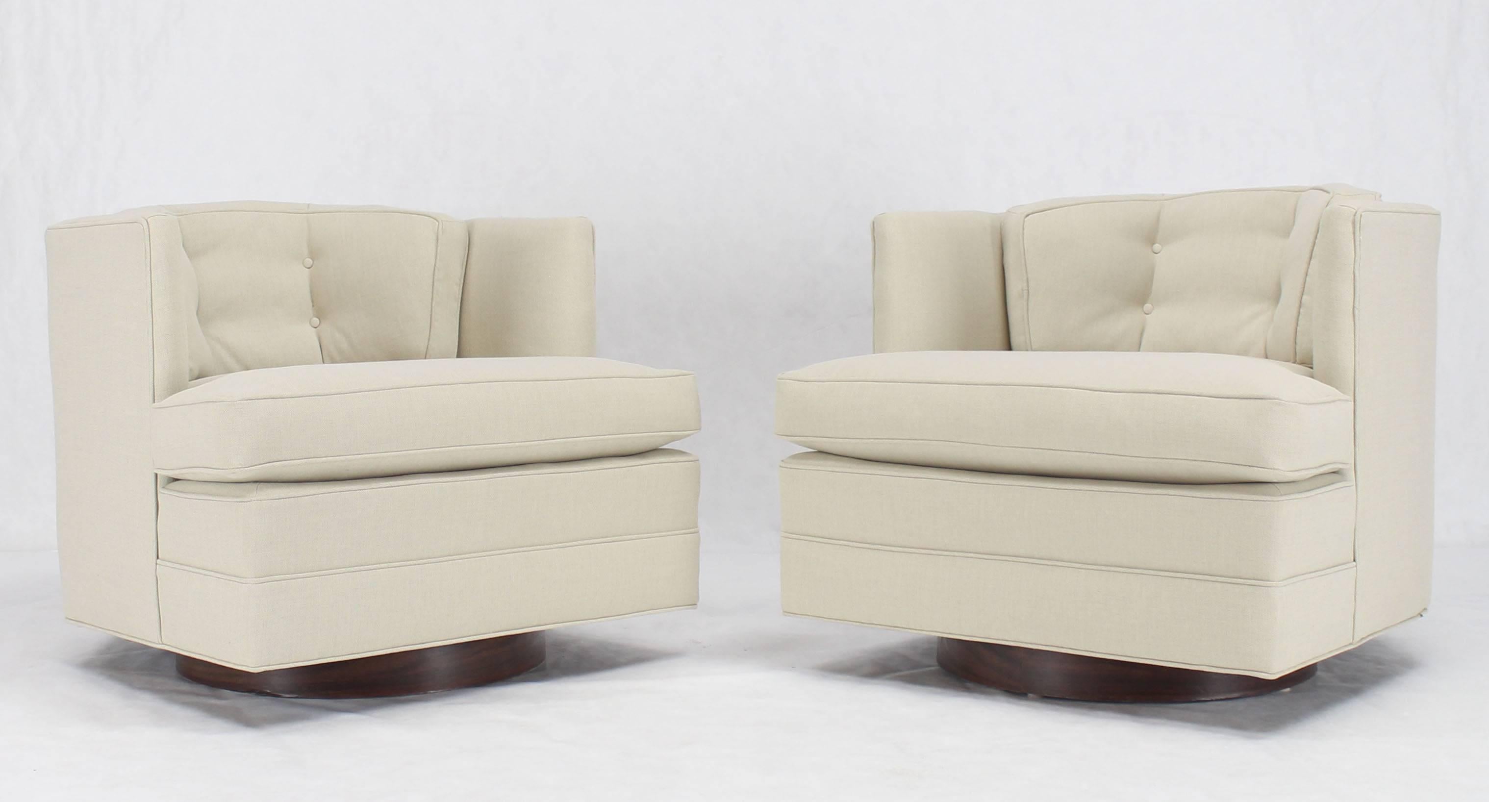 Pair of Mid-Century Modern swivel back lounge chairs with new upholstery.
