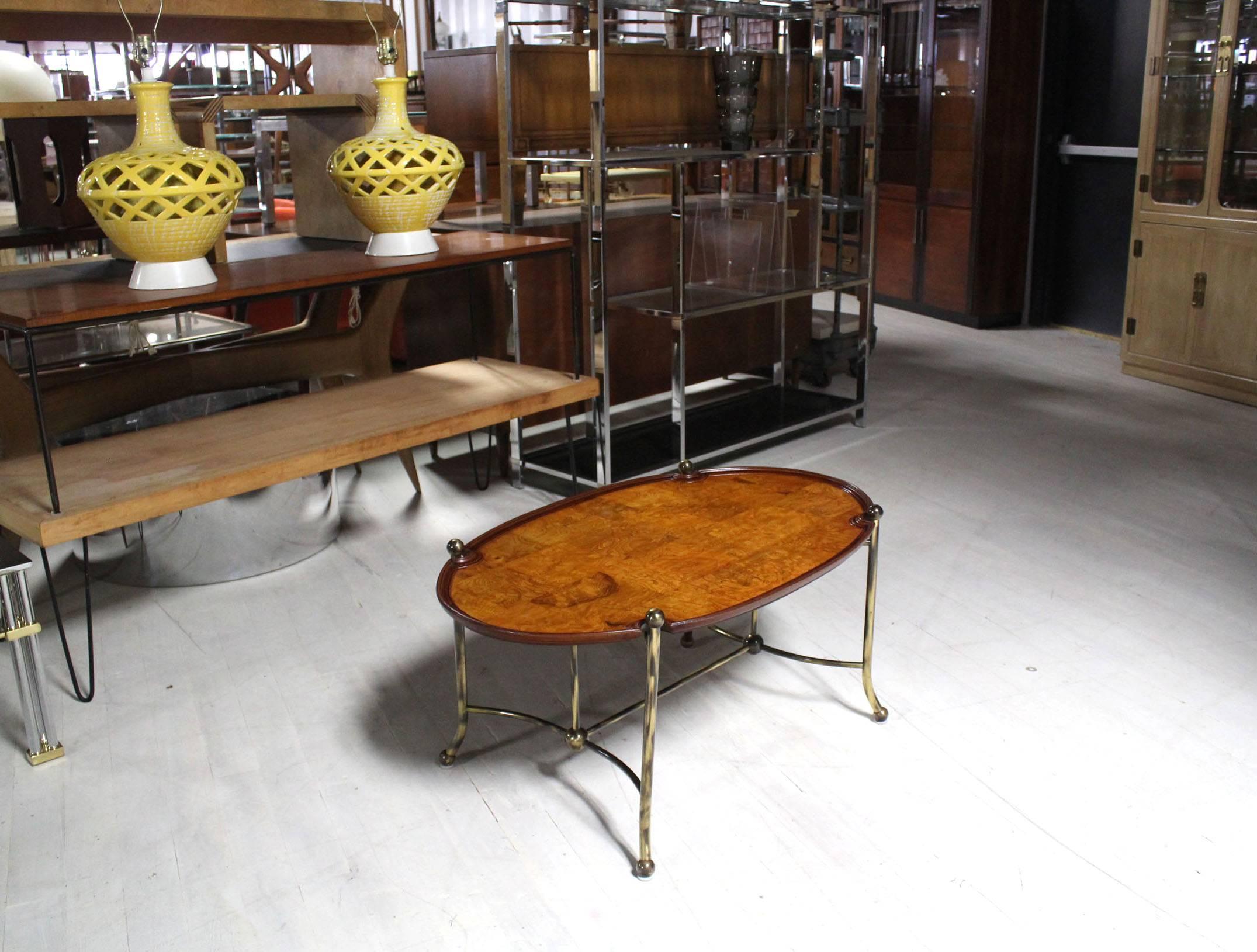 Nice decorative burl wood and brass oval coffee table.