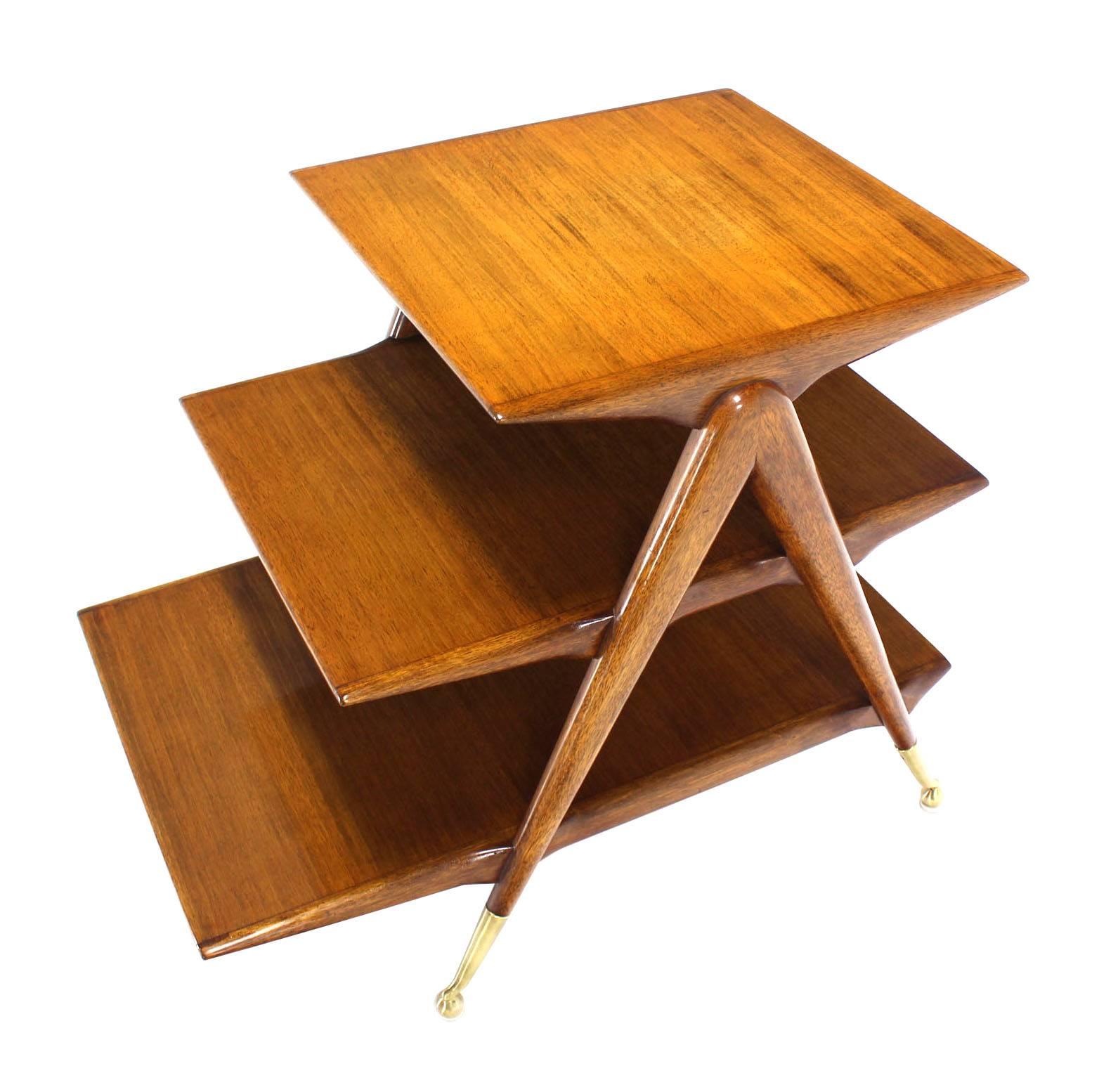 Very nice Mid-Century Modern three-tier side table or a magazine rack on compass shaped legs and metal ball feet. Excellent original condition.