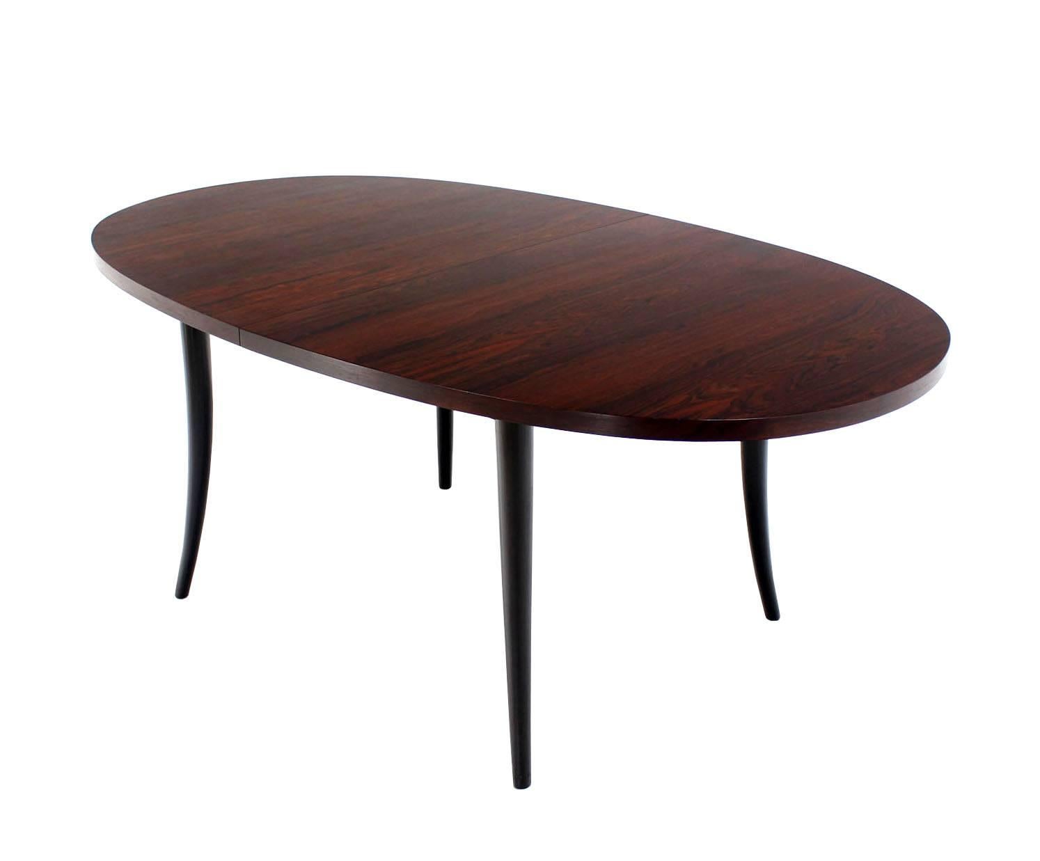 Outstanding Mid-Century Modern rosewood oval dining table with 4 16 inch leaves extension boards. Unmarked.