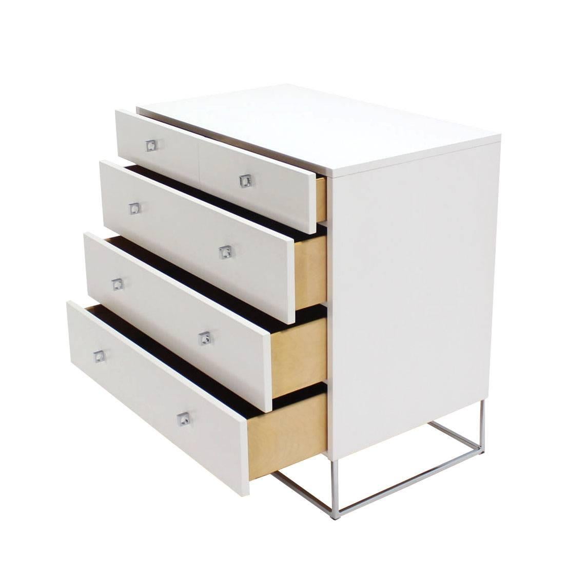 Pair of Mid-Century Modern white lacquered bachelor chests dressers on chrome bases.