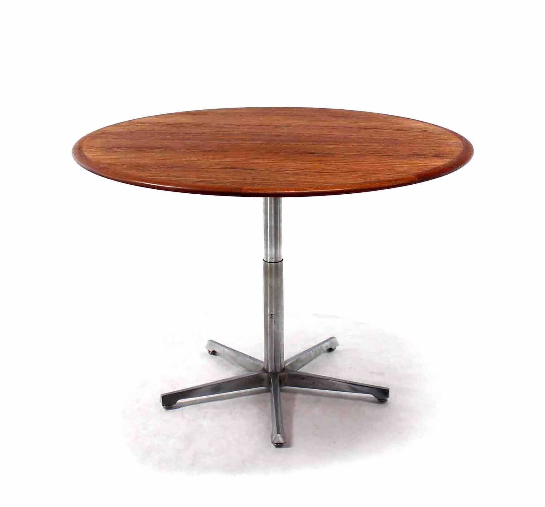 Round oiled walnut or teak top convertible coffee-dining table. Good quality craftsmanship.