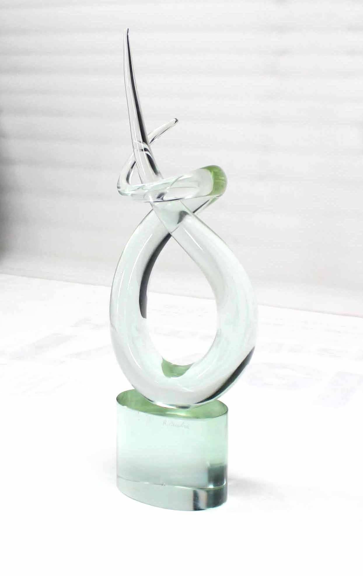 Very nice twisted horns motif pale green glass abstract sculpture on heavy oval glass base.