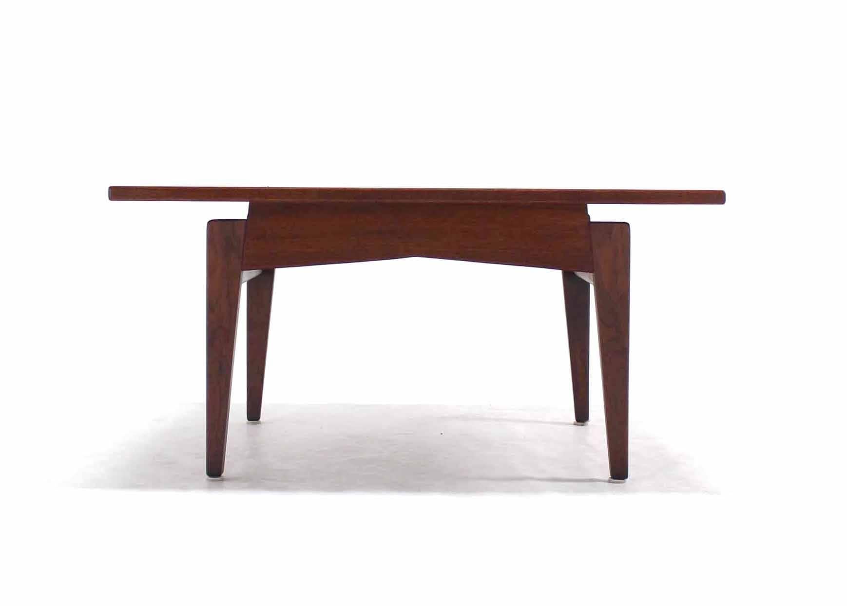 Solid square oiled walnut Jens Risom coffee table.