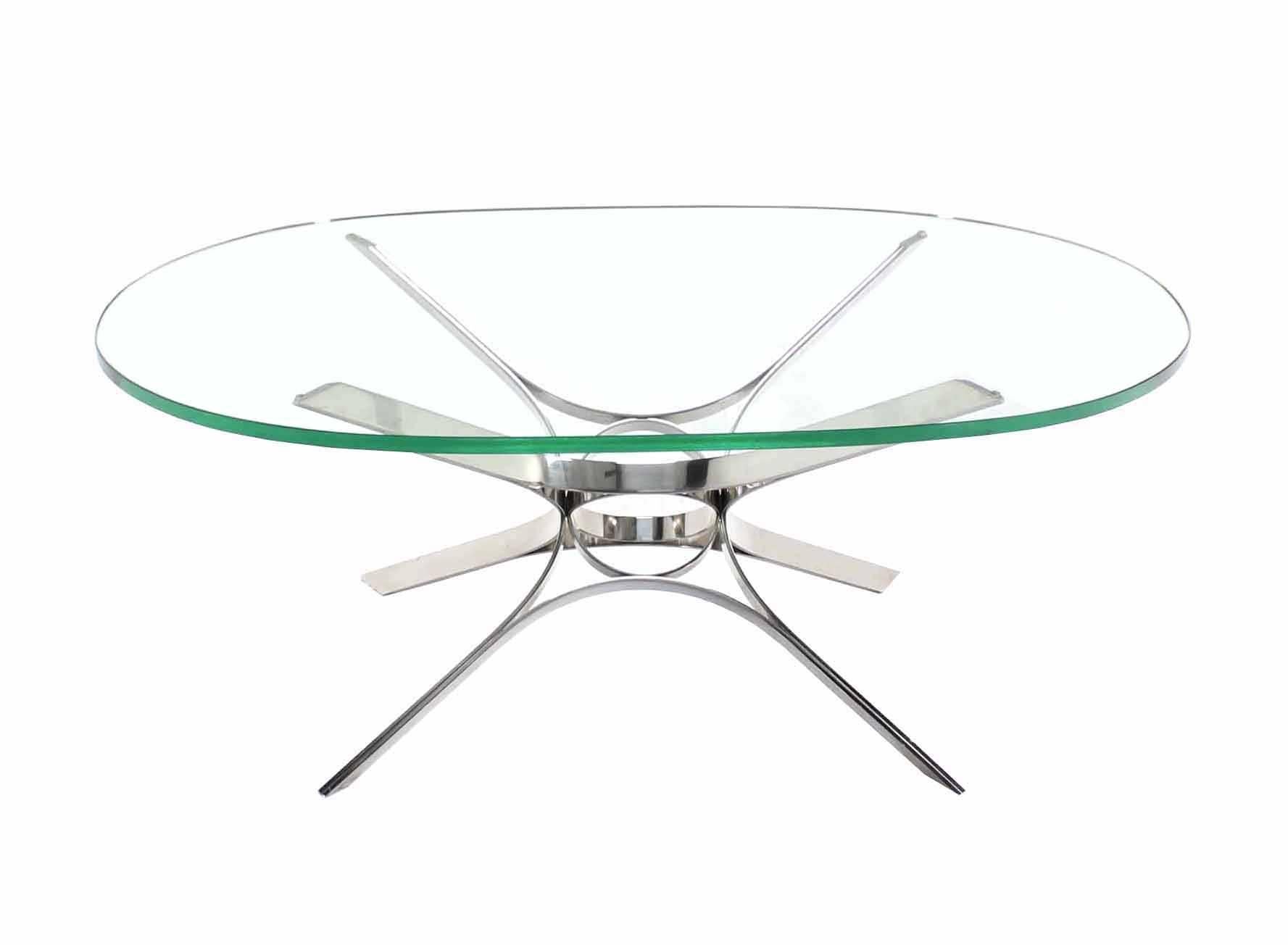 Thick glass top oval coffee table. The base is made of stainless steel band that is shaped and put together with an amazing precision.