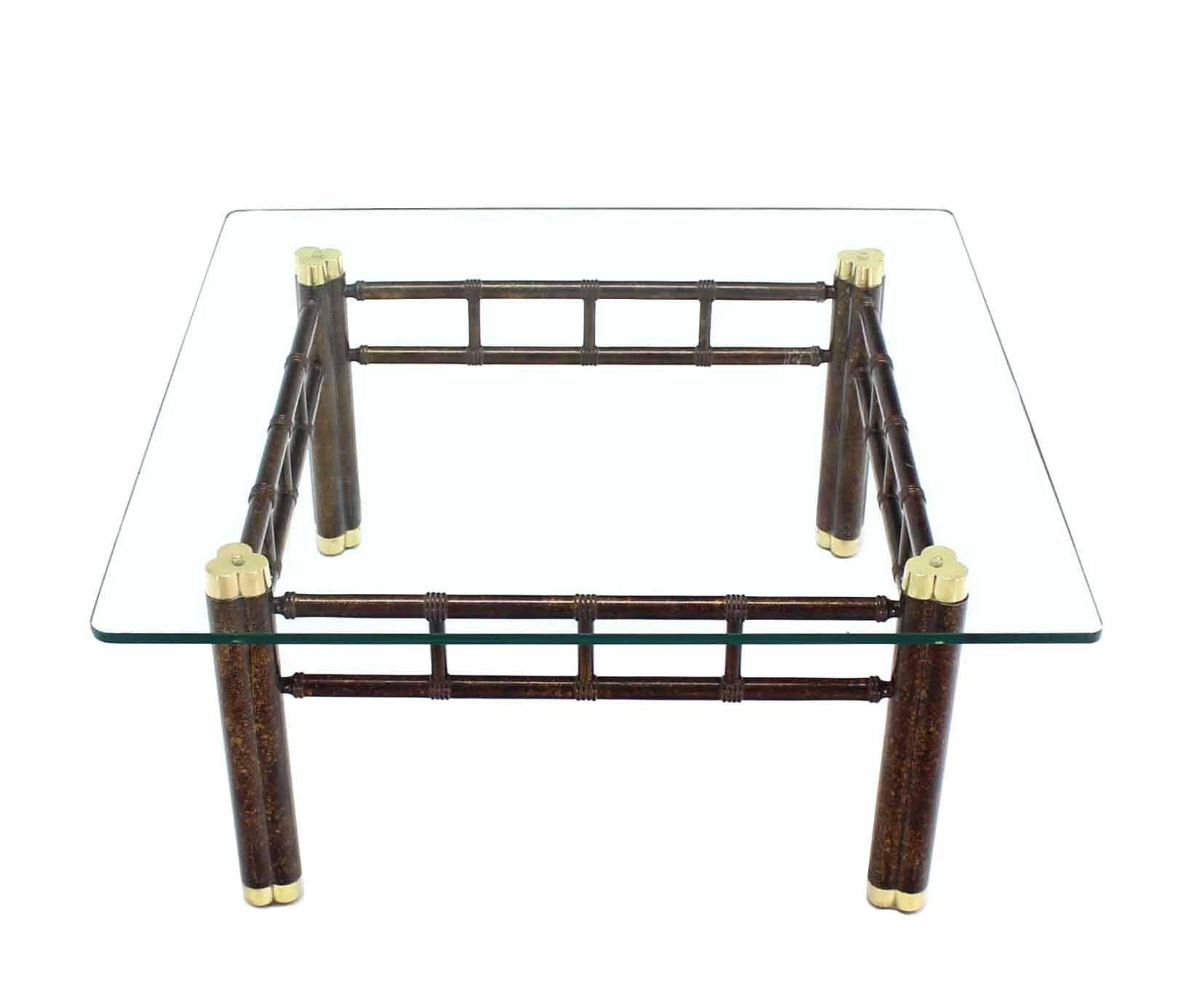 Nice tortoise finish with brass feet base coffee table with thick glass top.