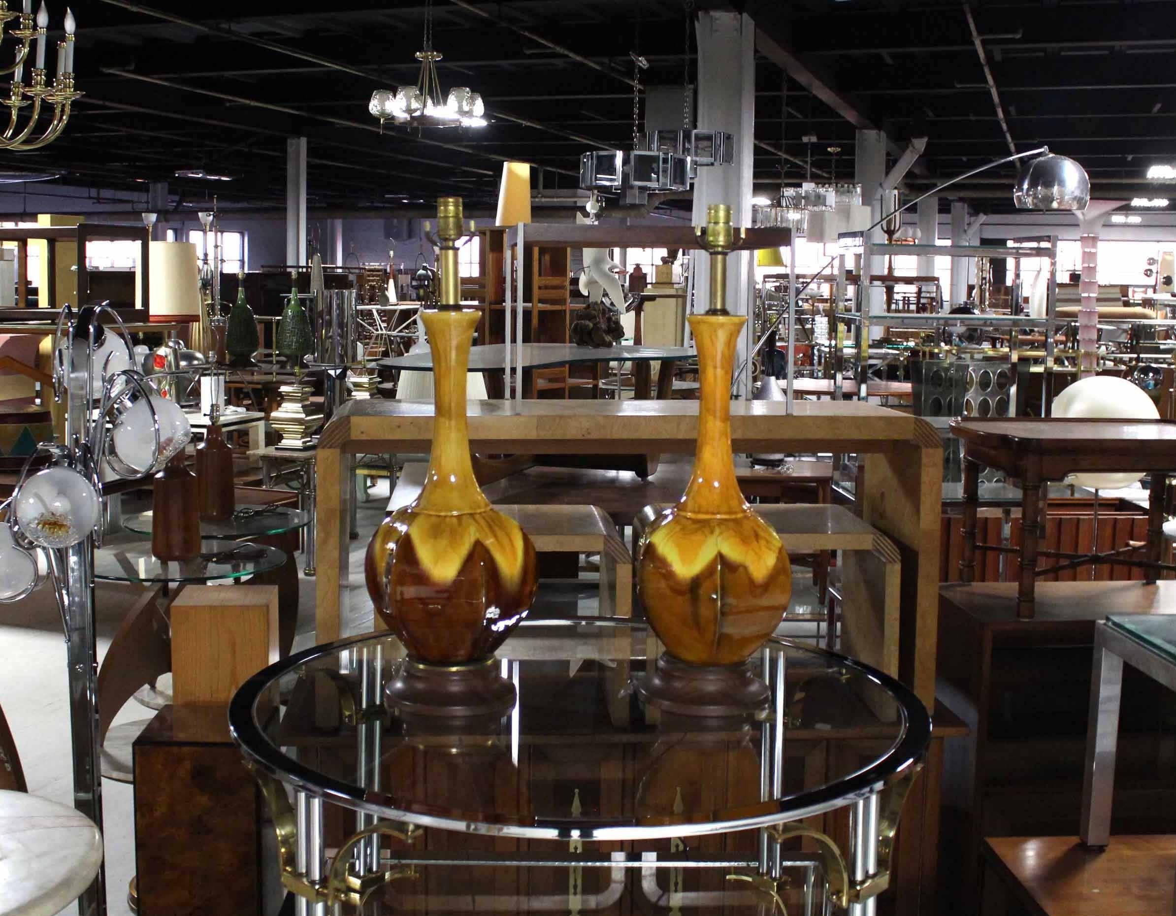 Pair of circa 1970s glazed pottery table lamps on turned walnut bases. Yellow and brown.