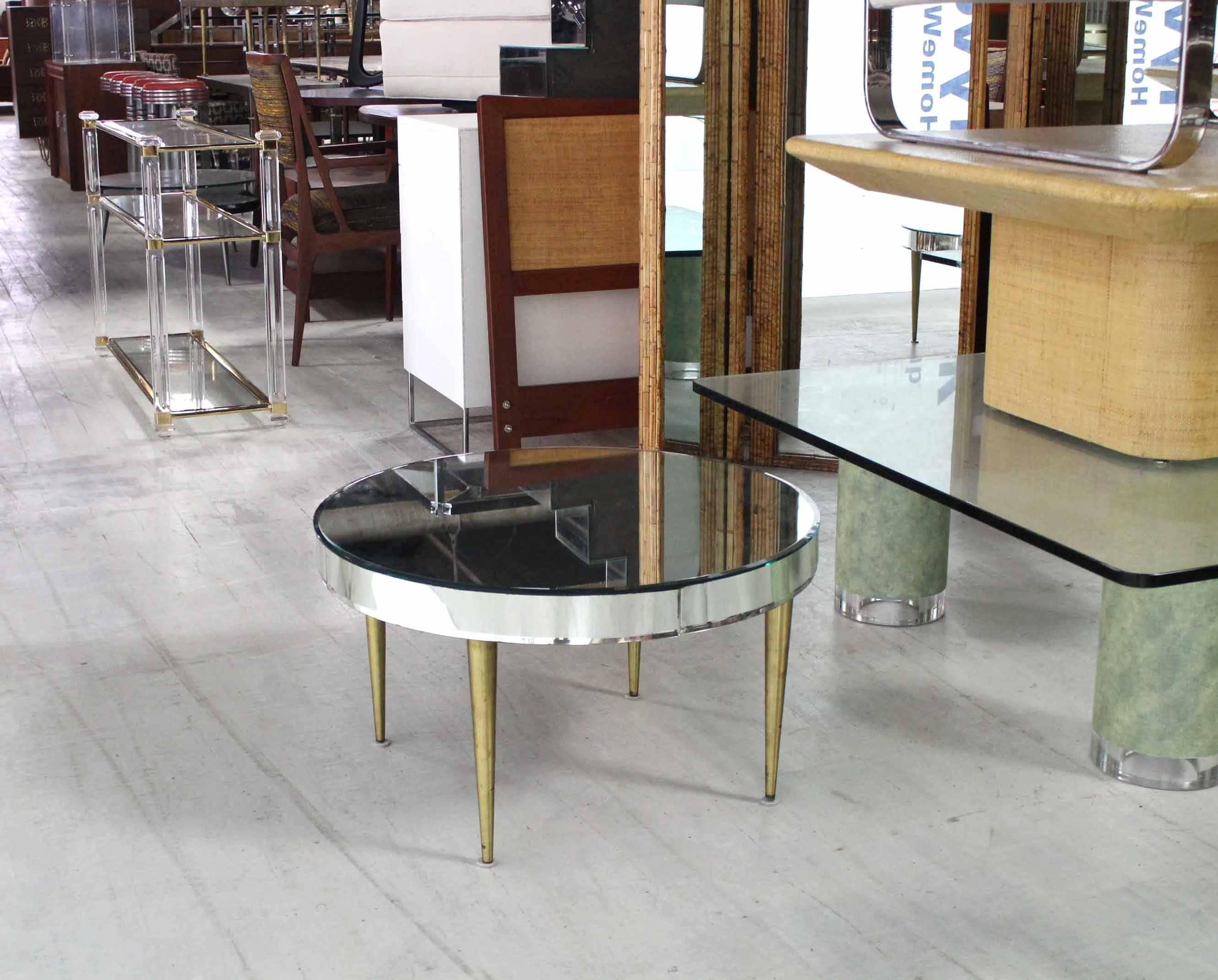 Nice mirrored drum shape midcentury table on tapered brass legs. Nice bent and bevelled glass banding around the edge.