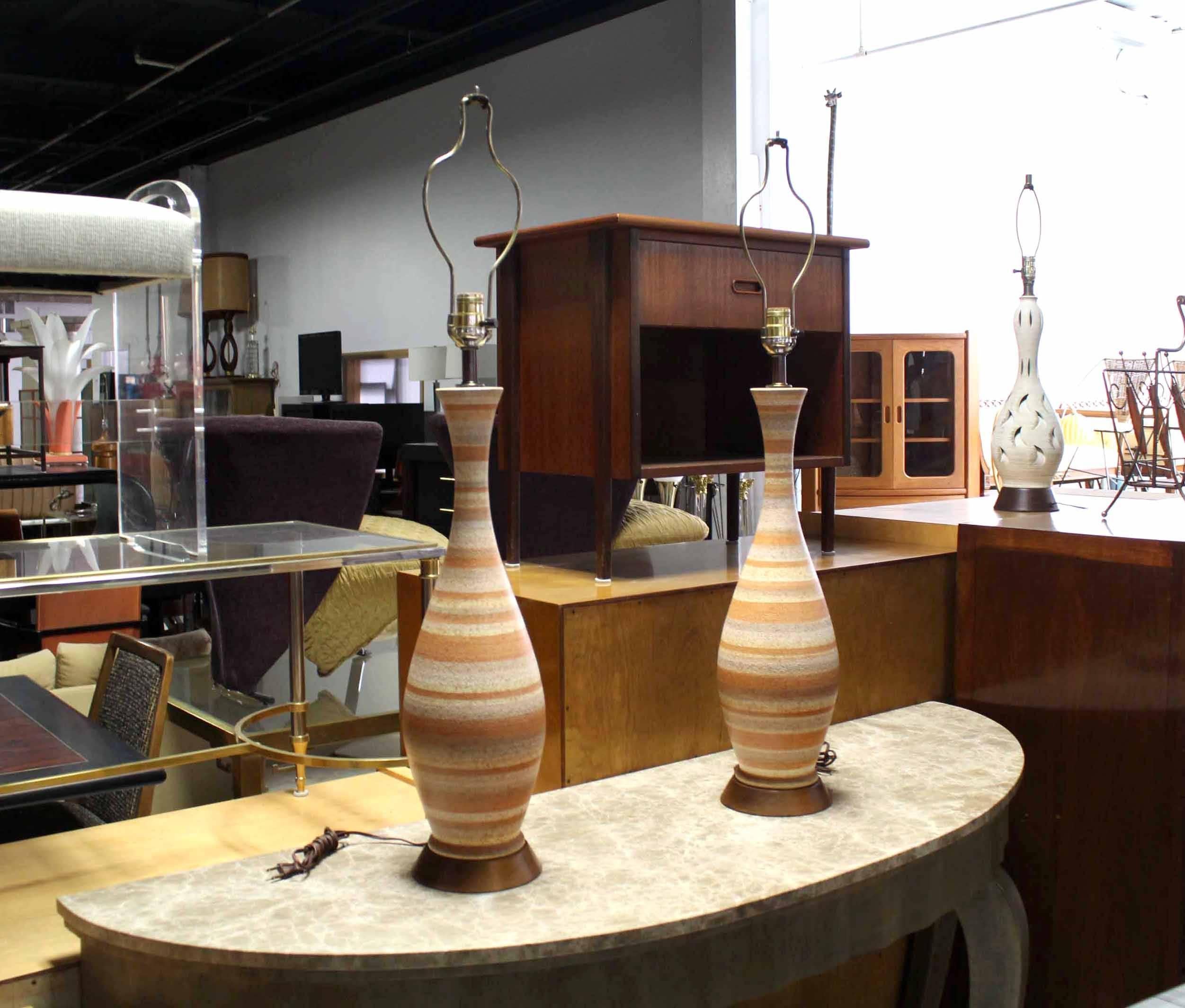 Walnut bases ceramic circular pattern table lamps. Brick color stripes on beige.