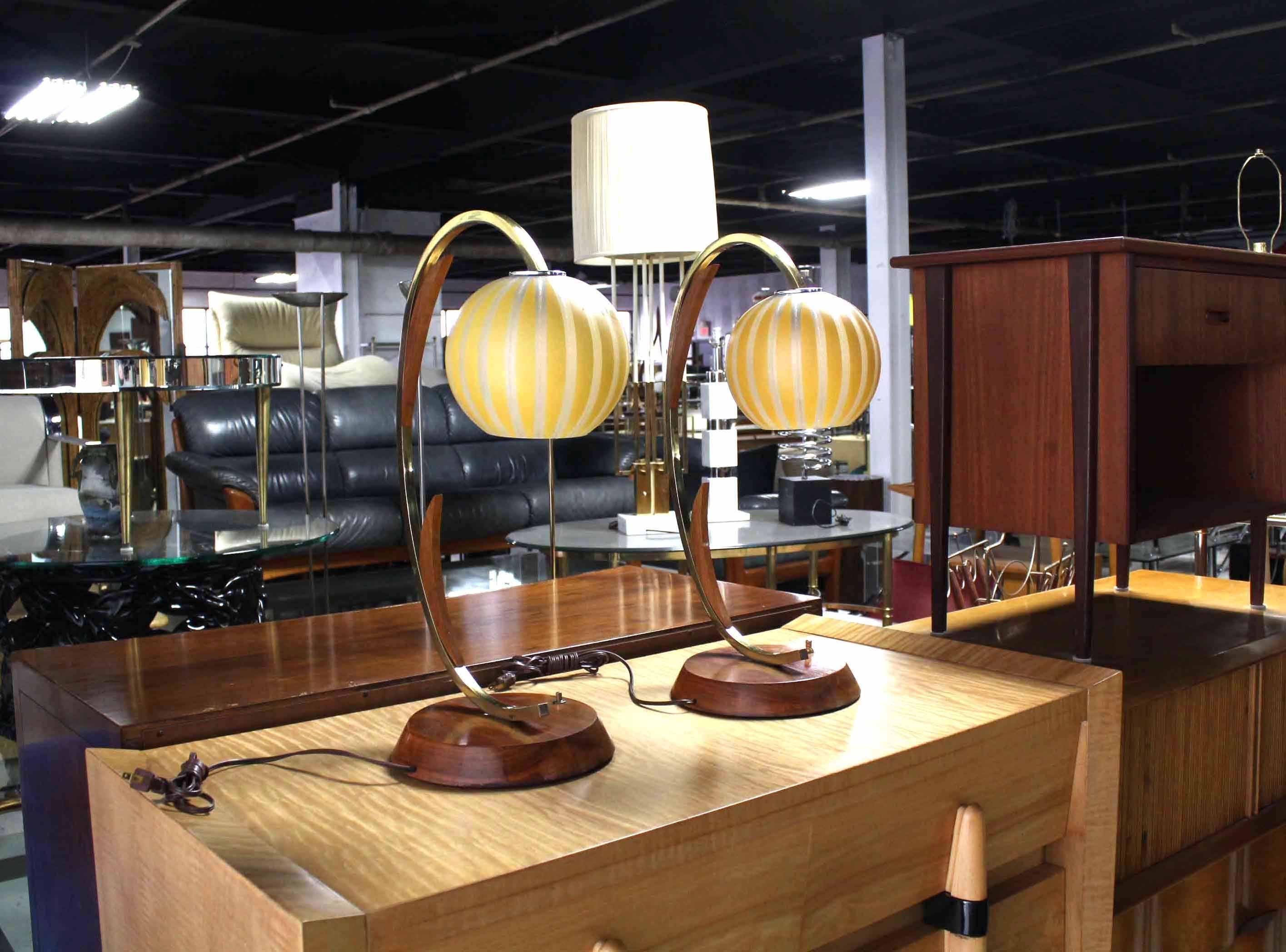Pair of lovely Mid-Century Modern walnut and brass bases table lamps with decorated glass globe shades.