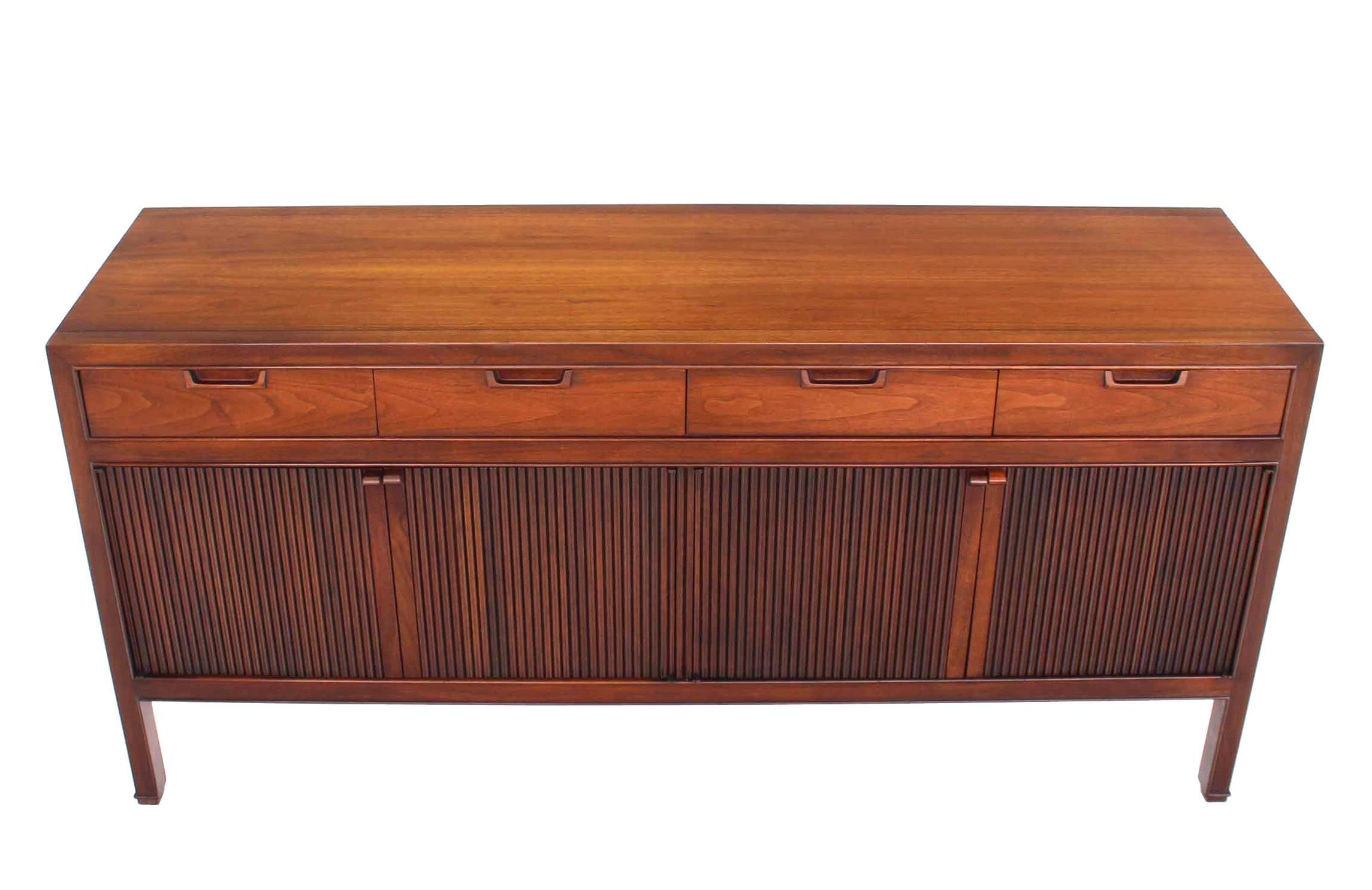 Super clean Mid Century Modern walnut long credenza dresser with fluted doors and four top drawers.