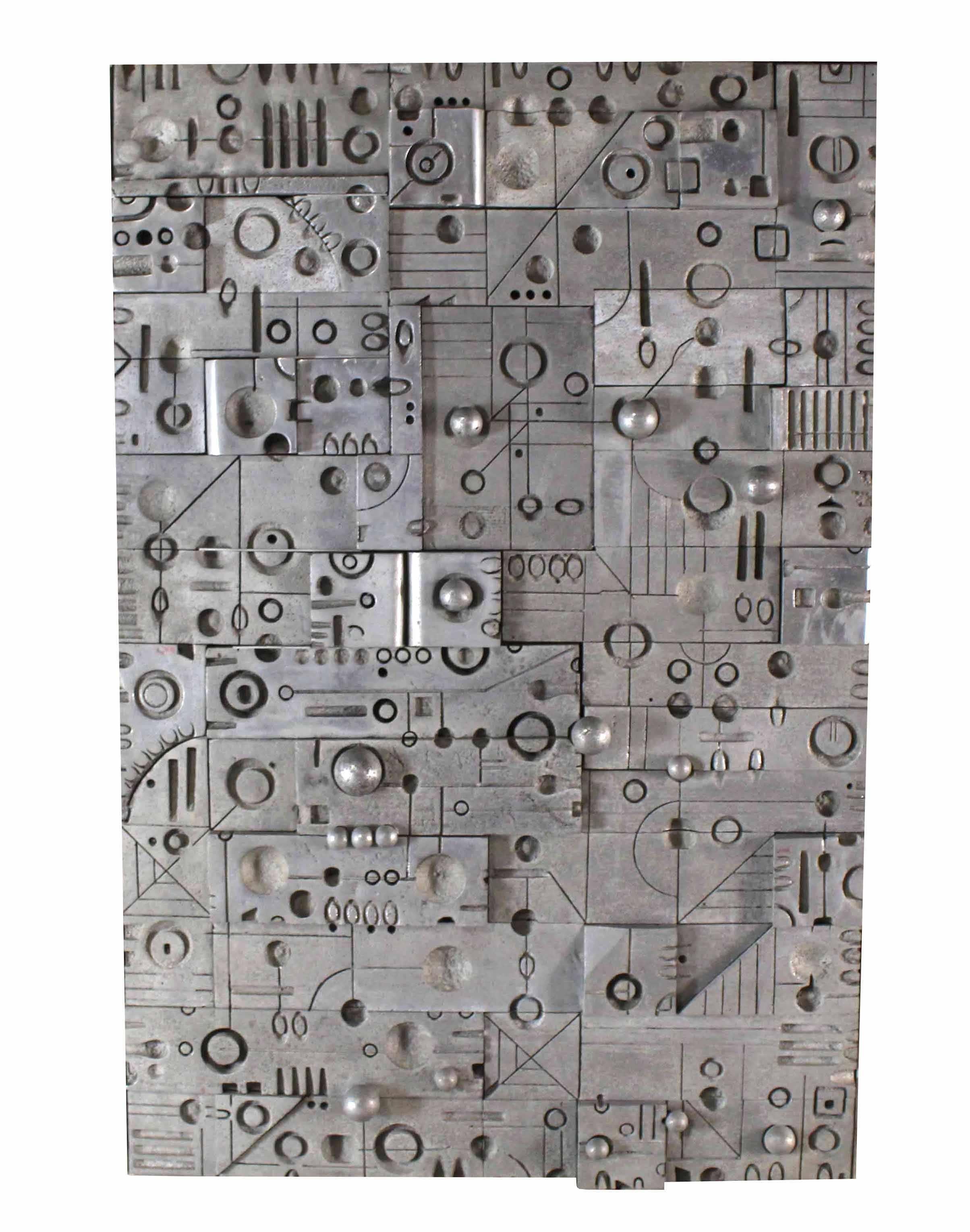 Very unusual wall panel or sculpture. Made up of a few different cast metal possibly aluminum puzzles. One of the puzzles opens and work like a secret door to high a safe. Outstanding craftsmenship and detail. Very rare piece.  Space age scene.     